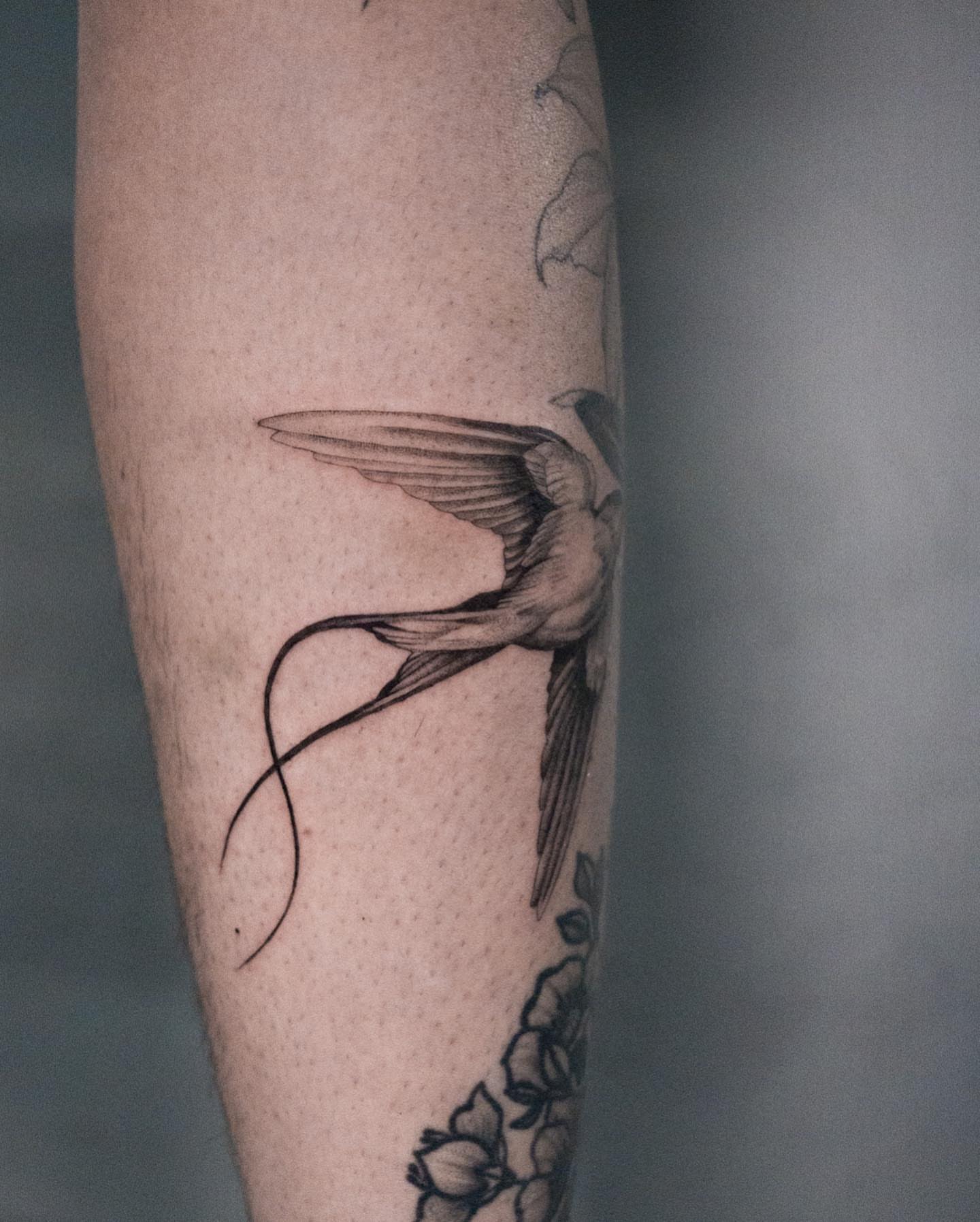 Swallow black and grey tattoo on the forearm by Valery Cardona