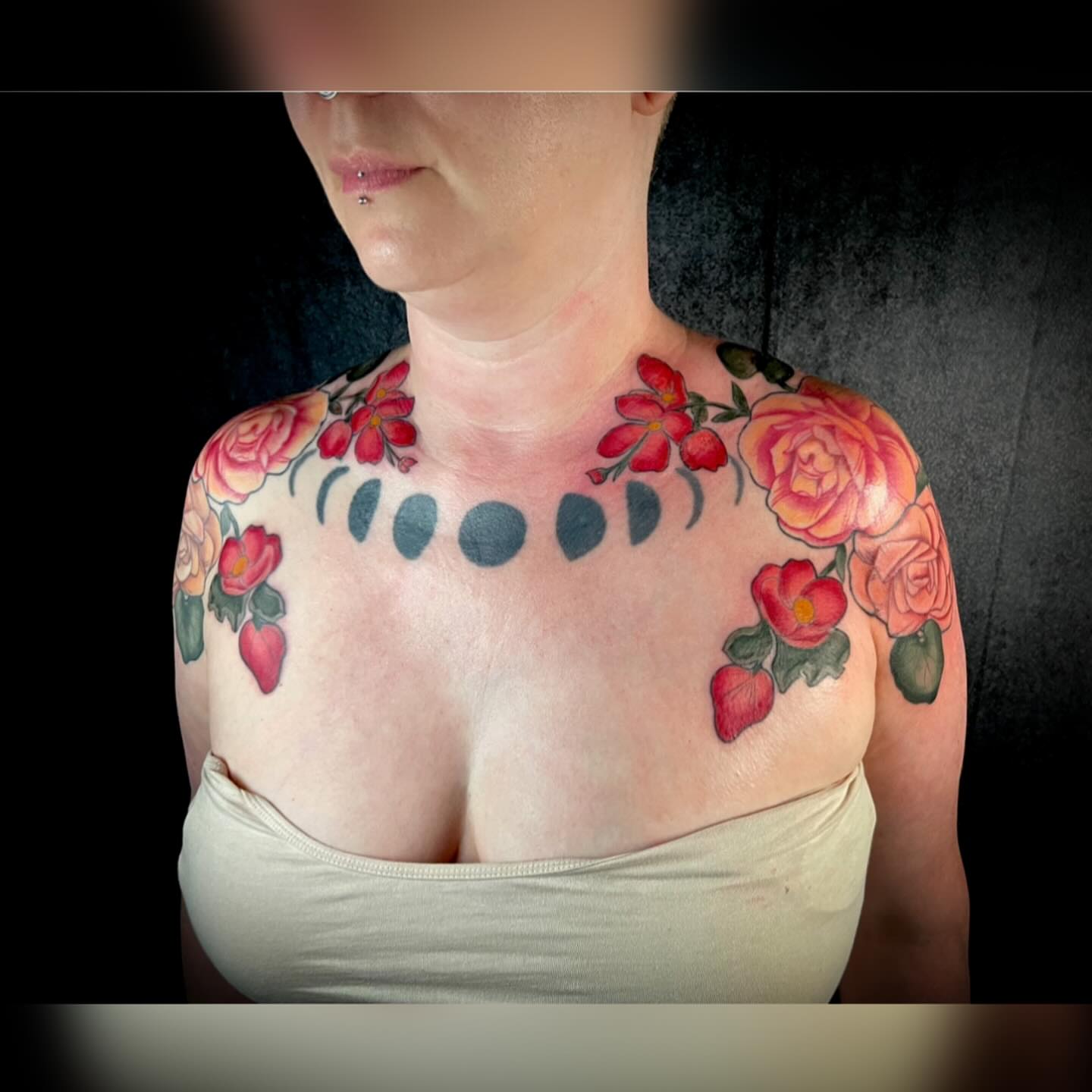 Flowers and moon phases realism tattoo on the chest by 𝓚𝓪𝓼𝓼𝓪𝓷𝓭𝓻𝓪 𝓜𝓬𝓒𝓪𝓵𝓵, Eugene, Oregon