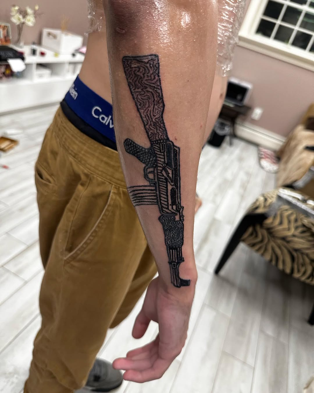 Assault rifle tattoo on the forearm by Silky Inks NJ 201, North Haledon, New Jersey