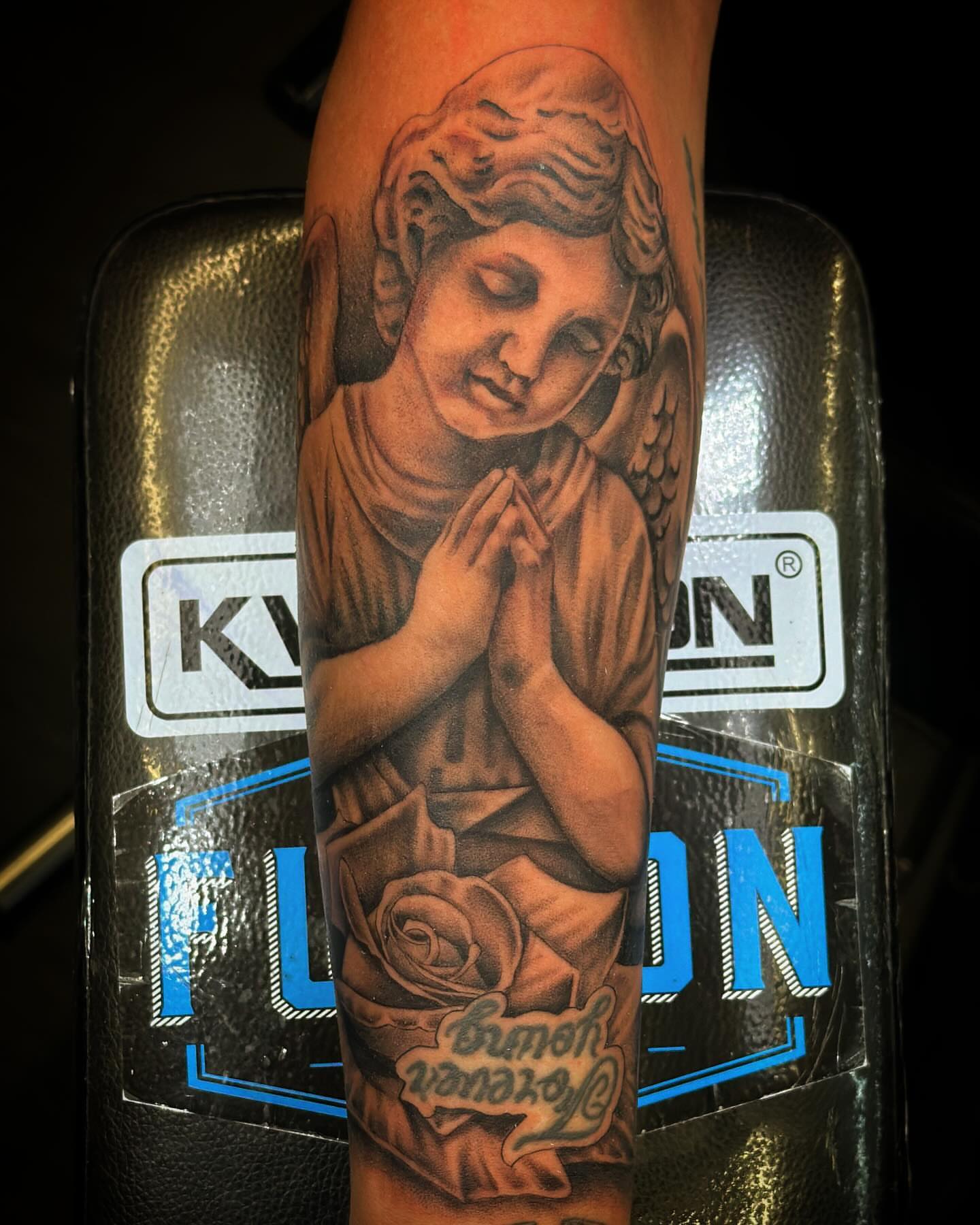Praying angel realism tattoo on the forearm by Dreamchaserink