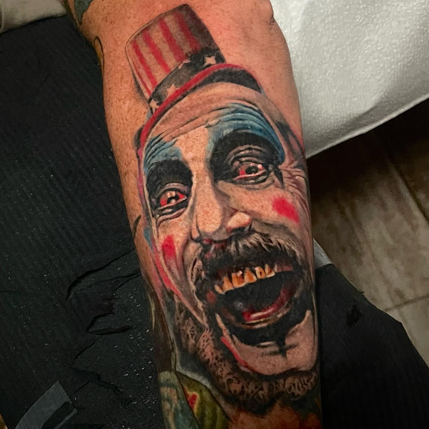Zombie clown realism tattoo on the forearm by Alex Rockoff