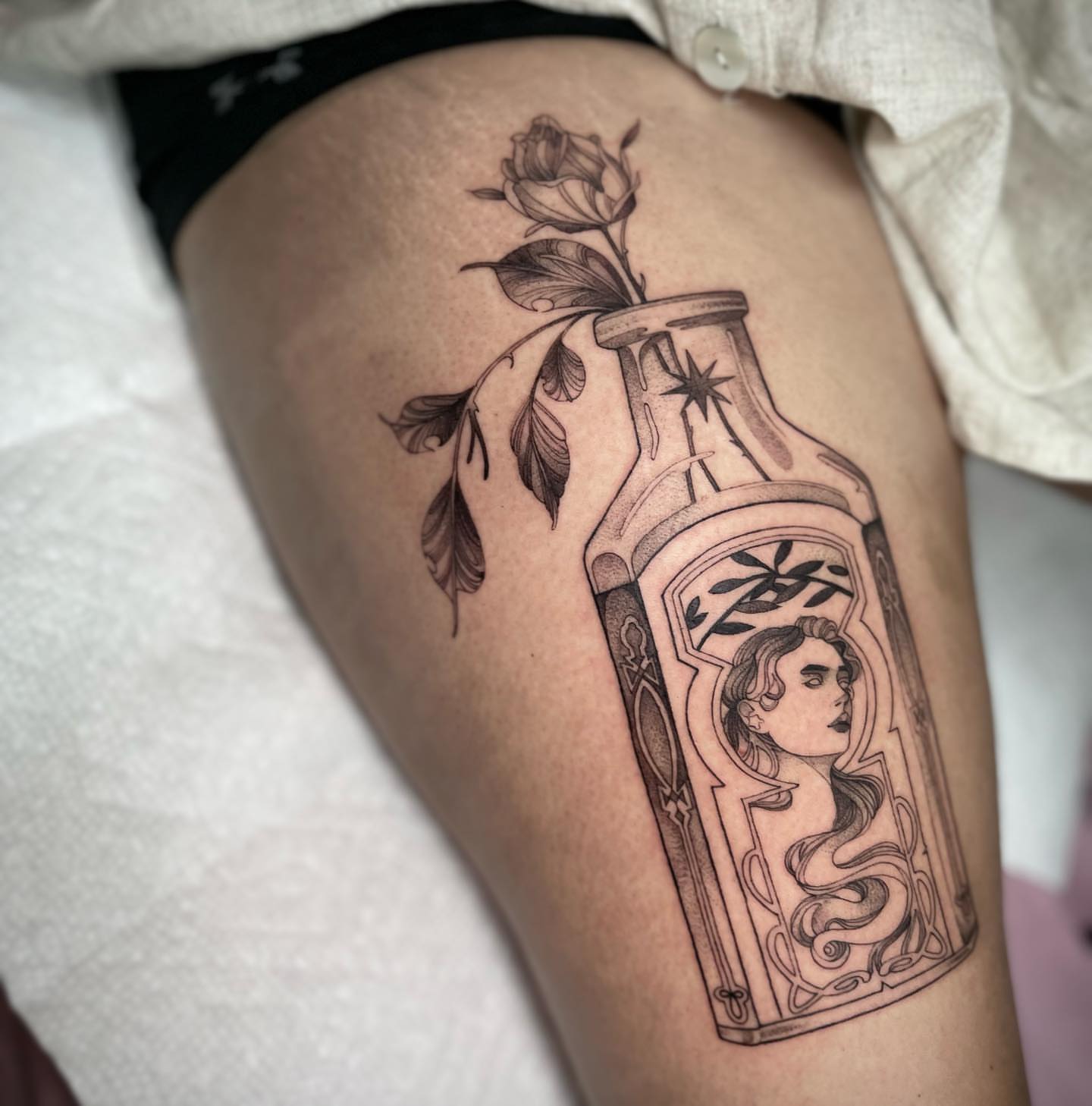 Bottle with woman portrait realism tattoo on the thigh by 𝑅𝑒𝑒𝓈𝒶 𝐿𝓎𝓃𝓃 ₊ ⊹❀