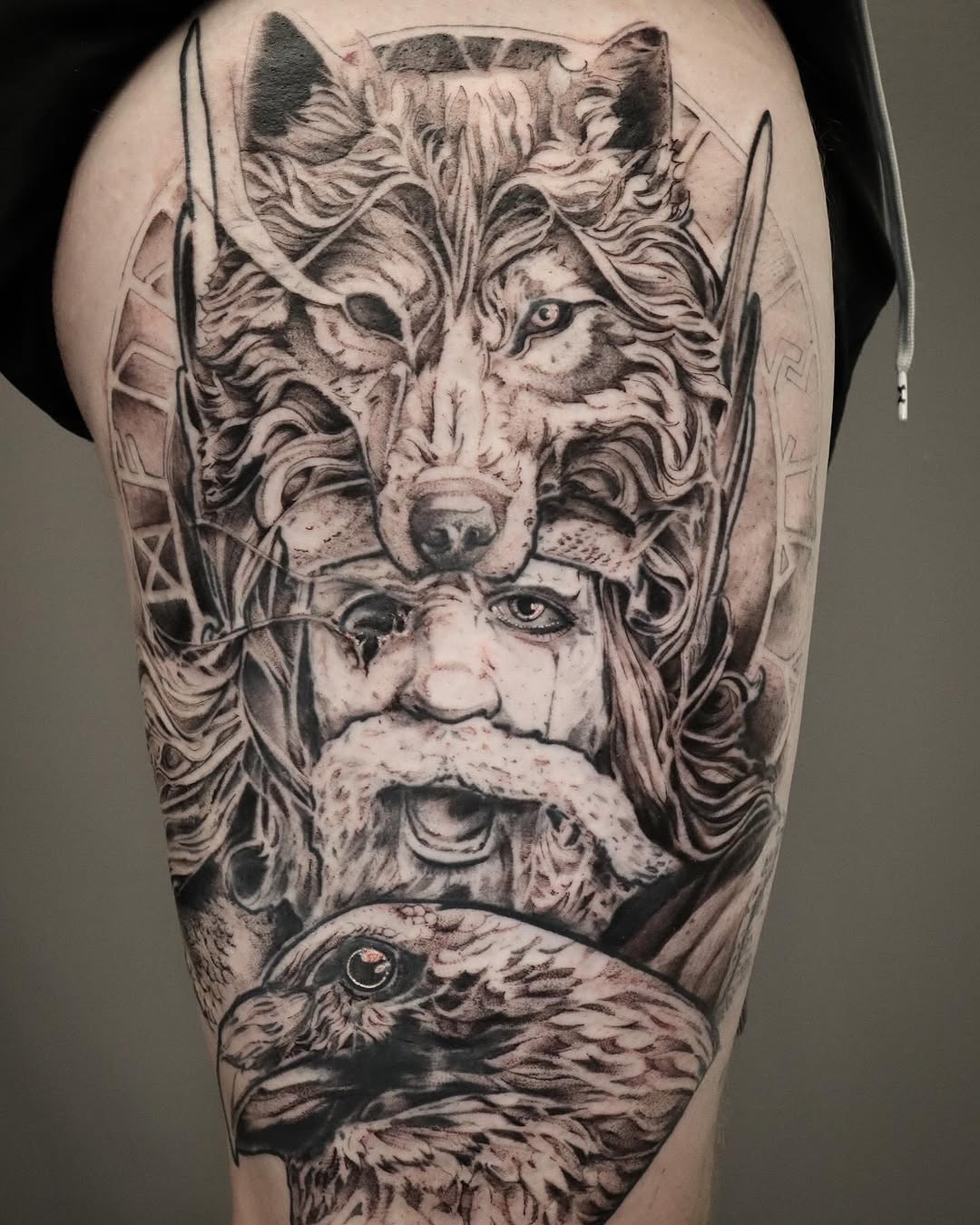 Viking god with wolf and raven realism tattoo on the forearm by Joe Hall