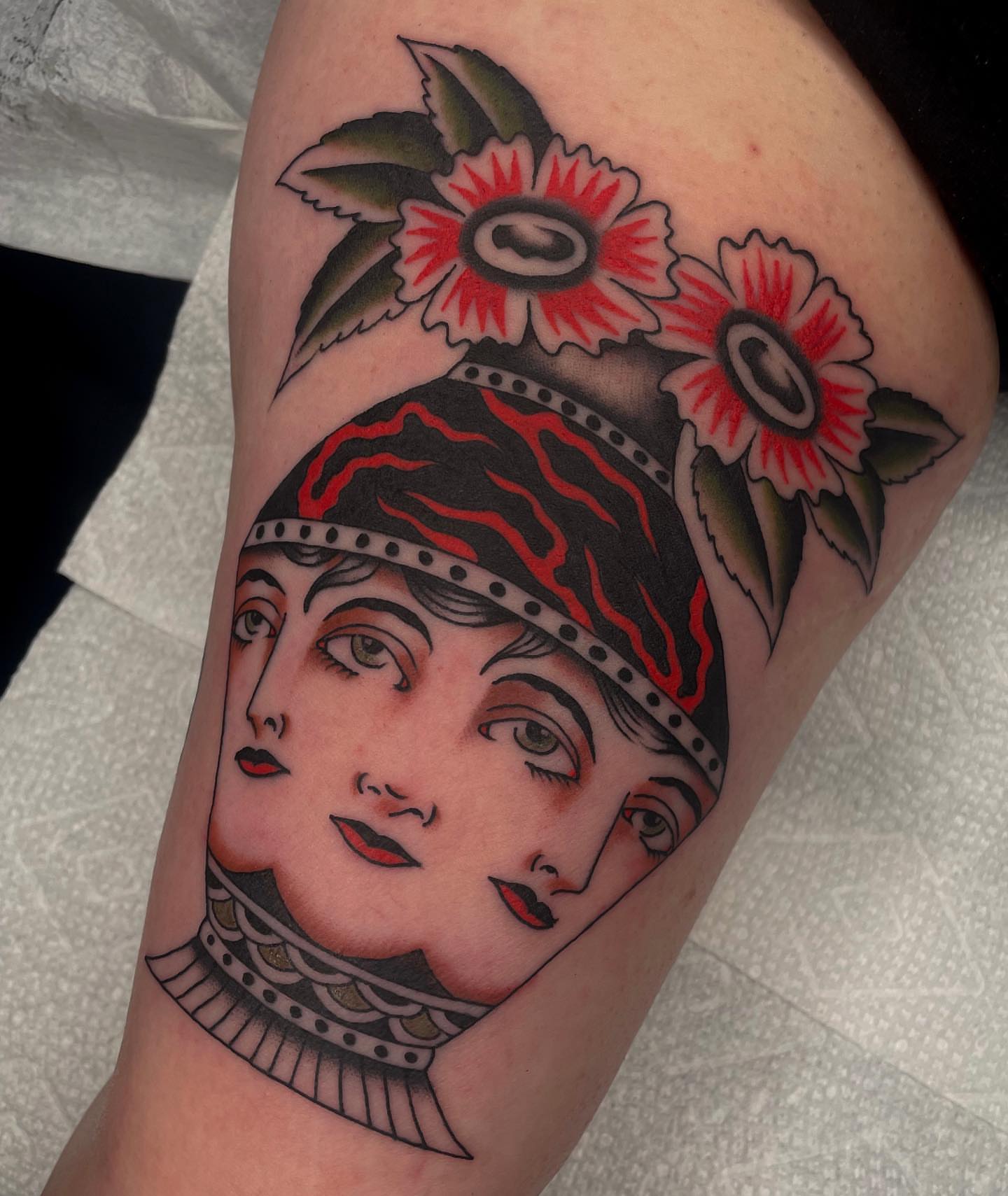 Woman's head American traditional tattoo on the thigh by Toulouse Noble, Portland, Oregon