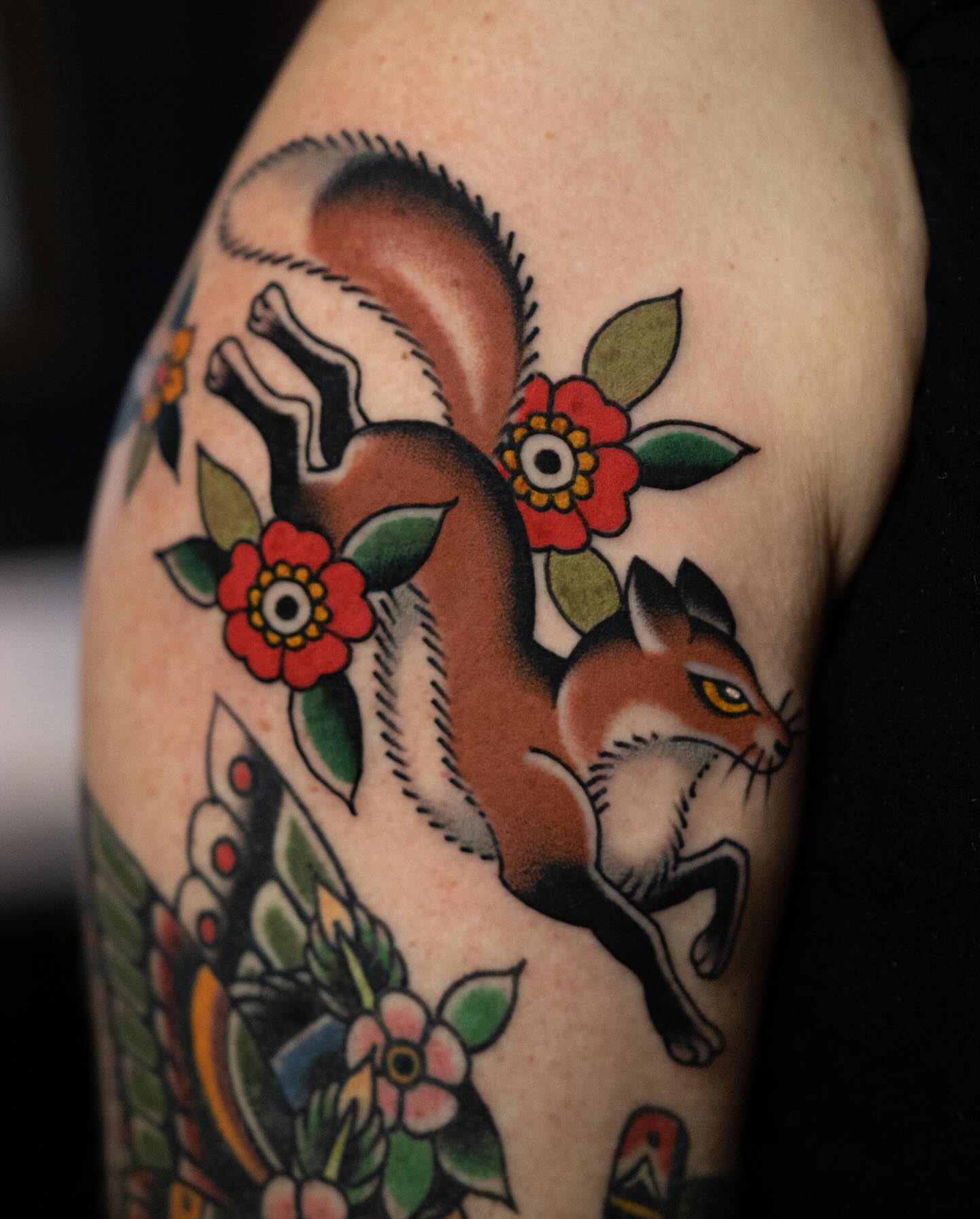 Squirrel and flowers American traditional tattoo on the forearm by Danny Derrick, San Luis Obispo, California