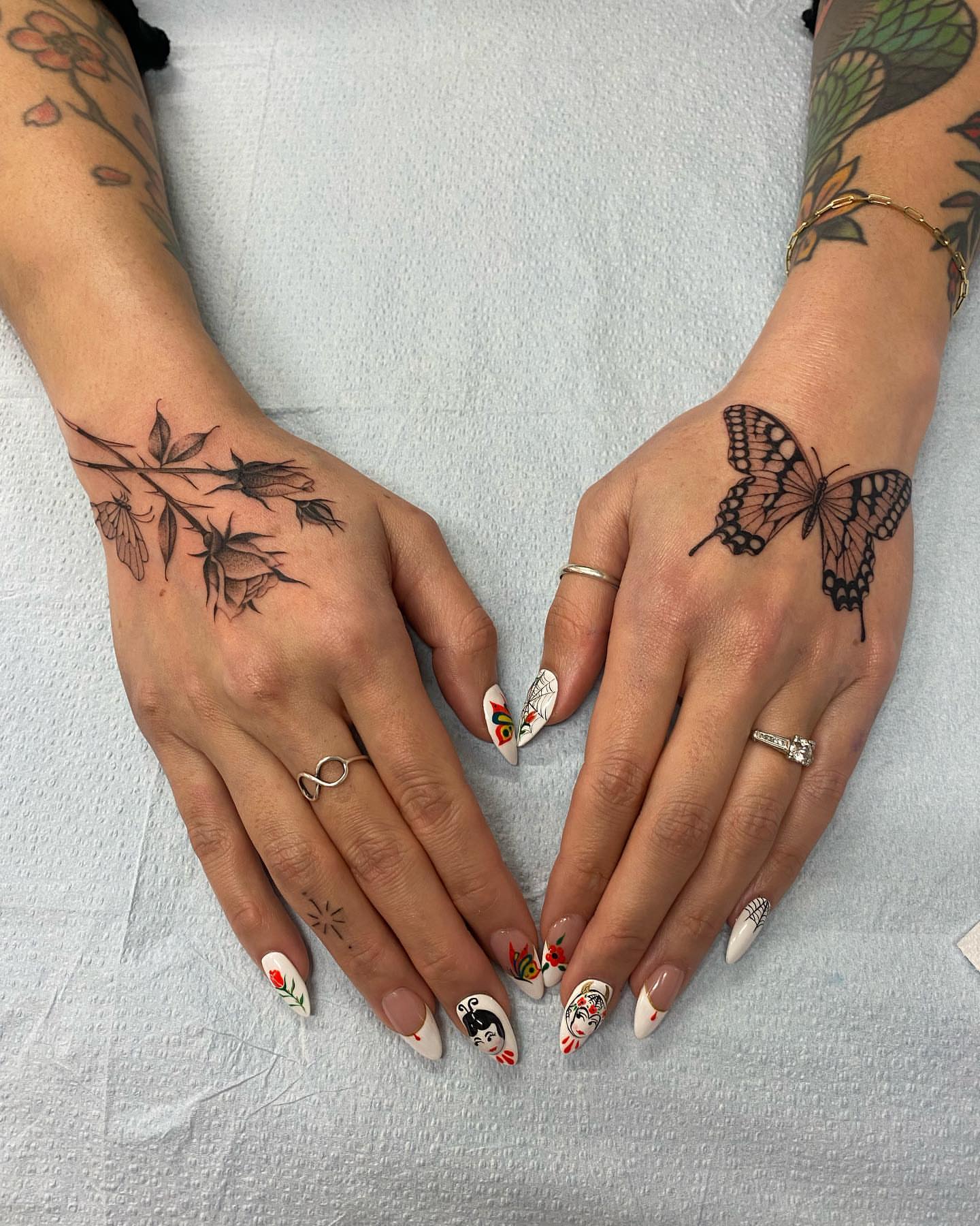 Flower branch and butterfly black and grey tattoo on the hand by Alan Pham, San Jose, California