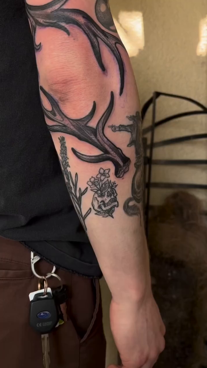 Antlers and flowers dark realism tattoo by Daniel Patrick