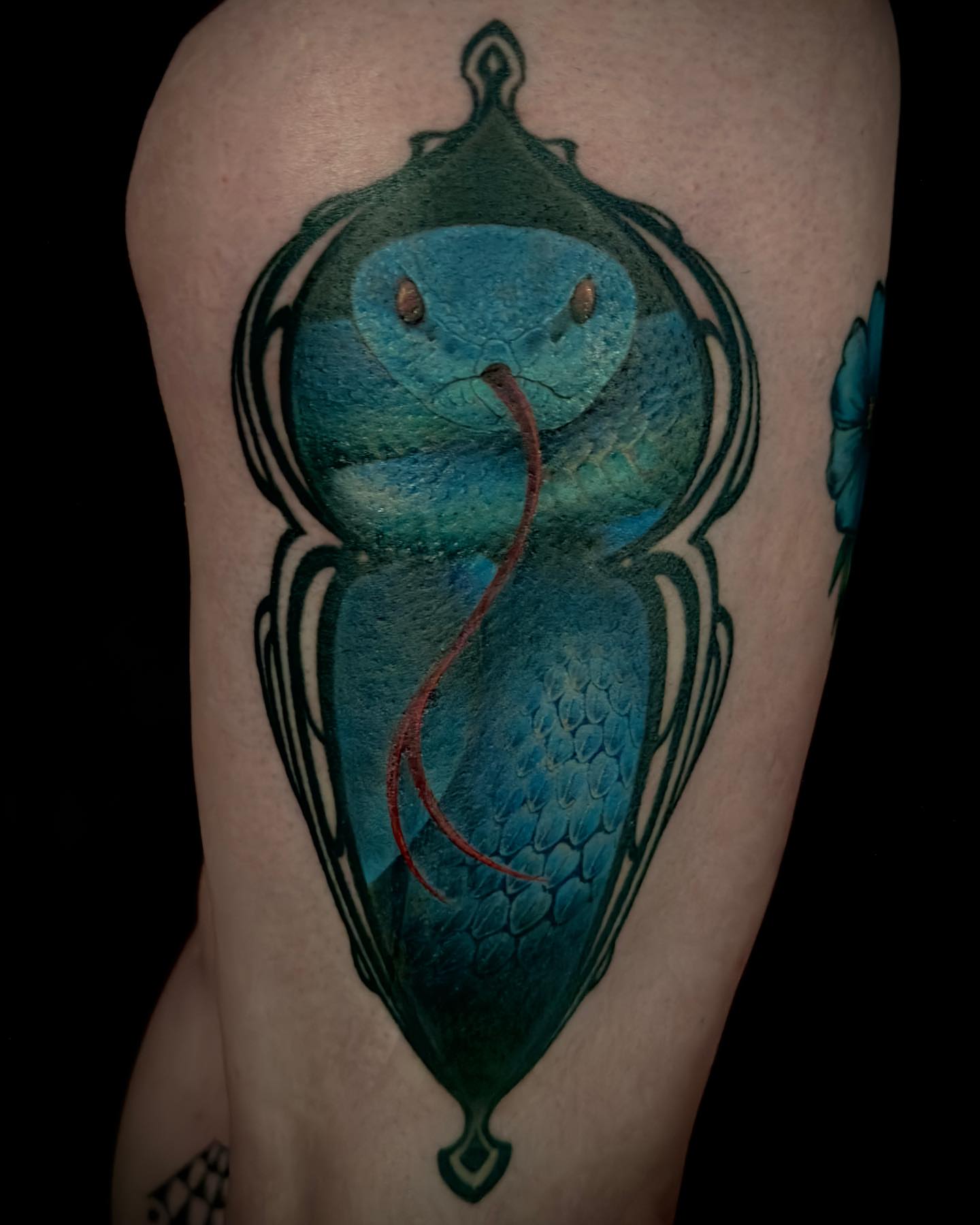 Snake watercolor tattoo on the thigh by Nic Luna