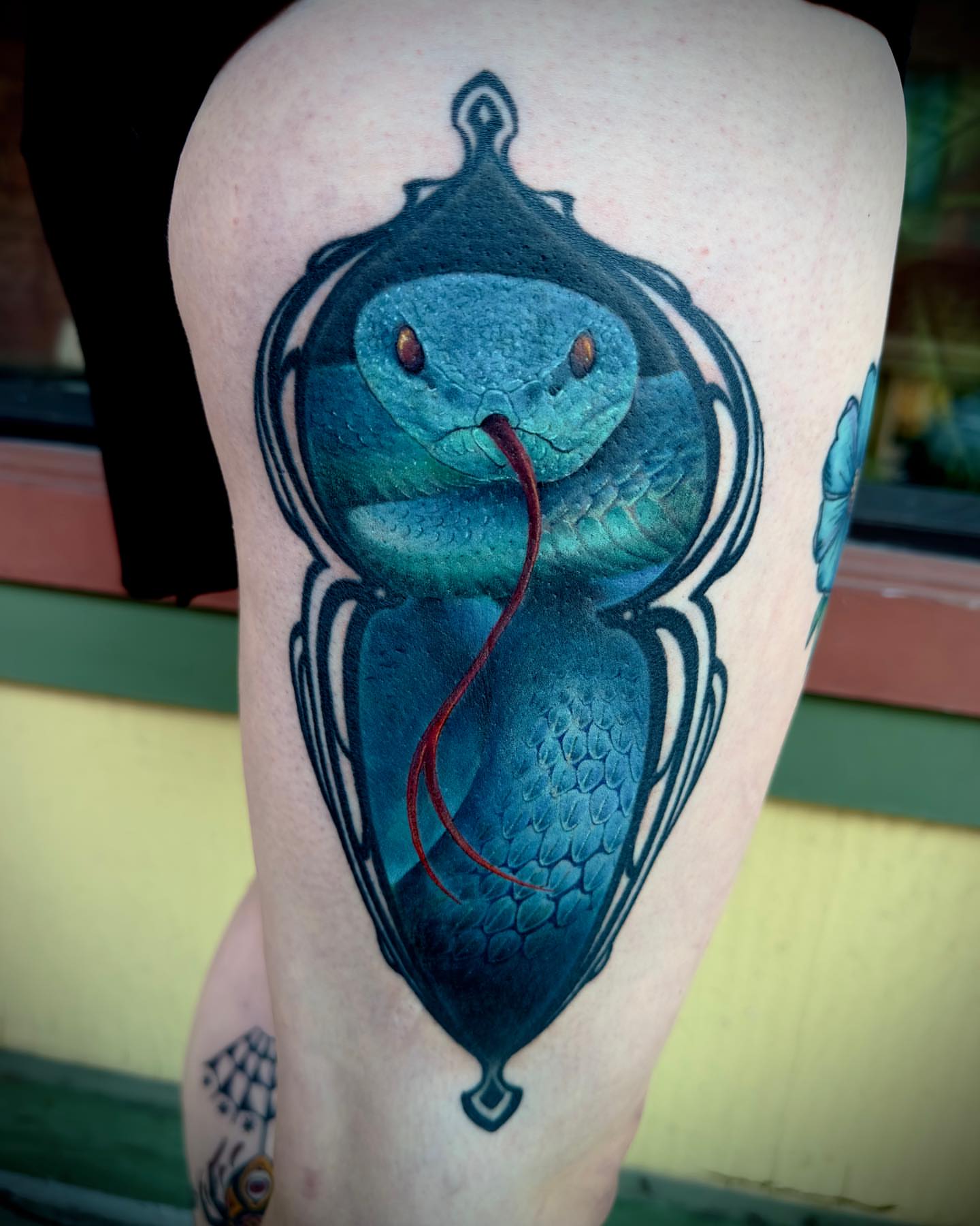 Snake realism tattoo on the thigh by Nic Luna