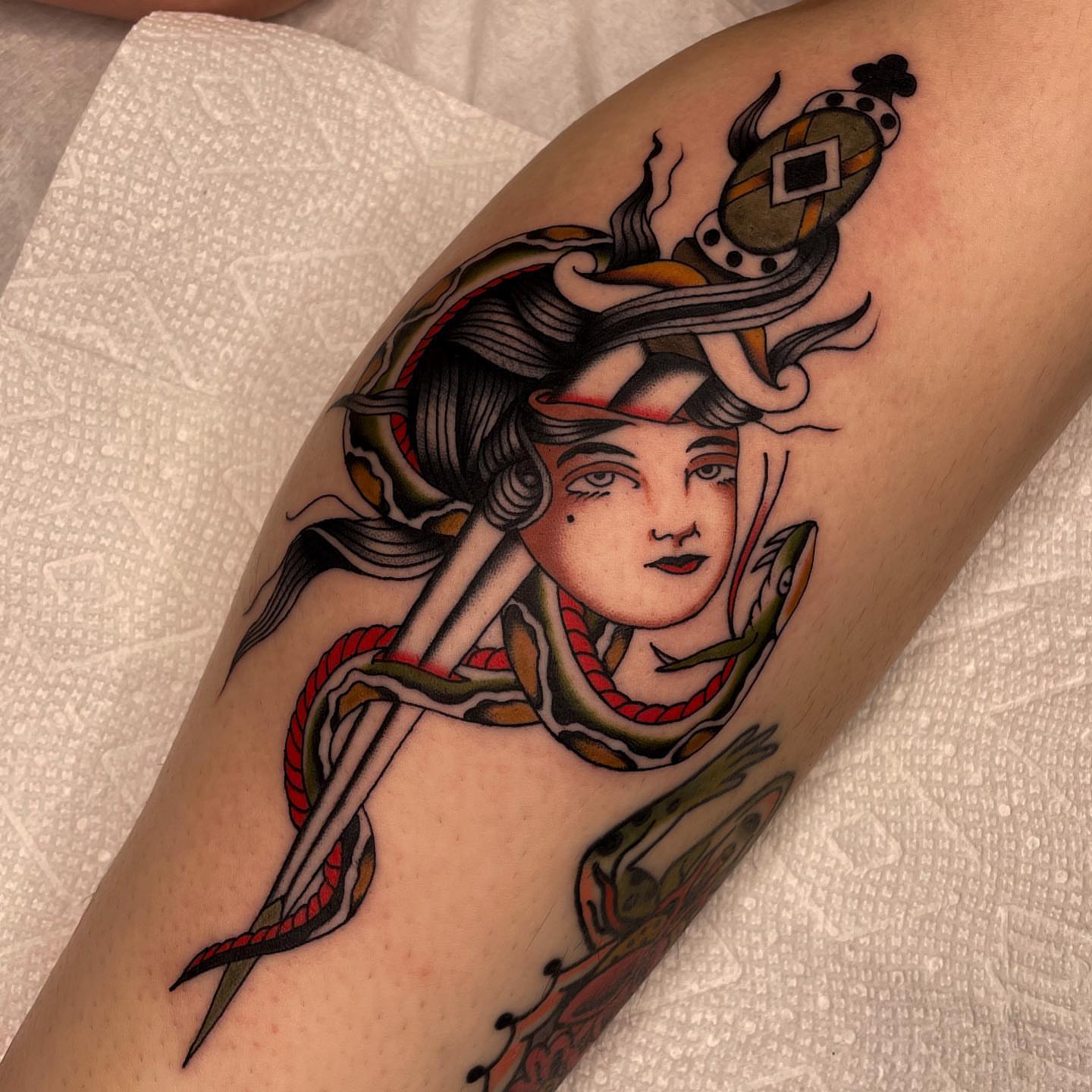 Woman with snake American traditional tattoo on the forearm by Toulouse Noble, Portland, Oregon