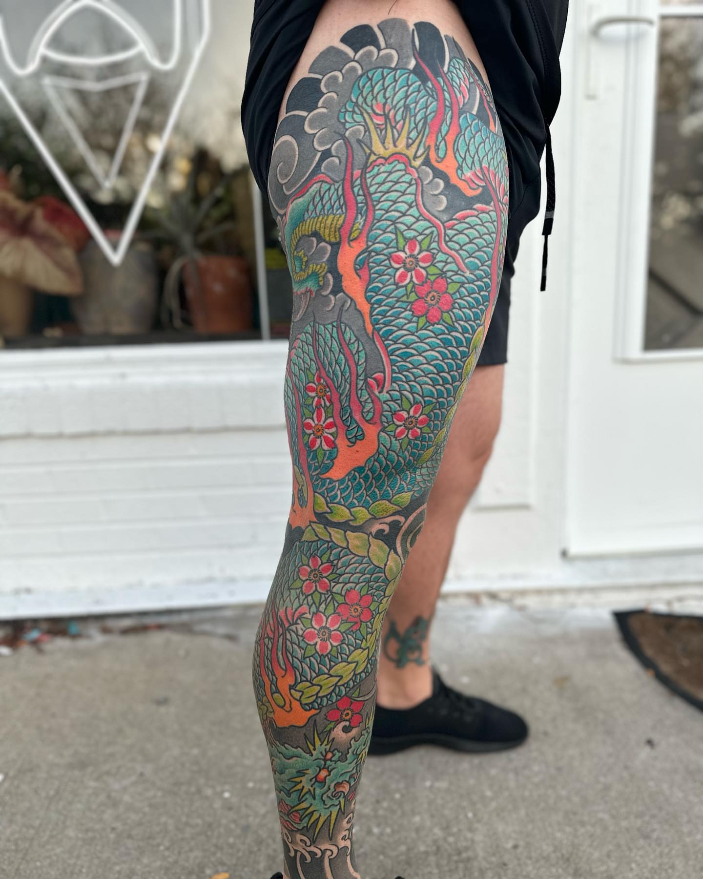 Dragon and flowers japanese irezumi tattoo on the thigh by Chris Rogers