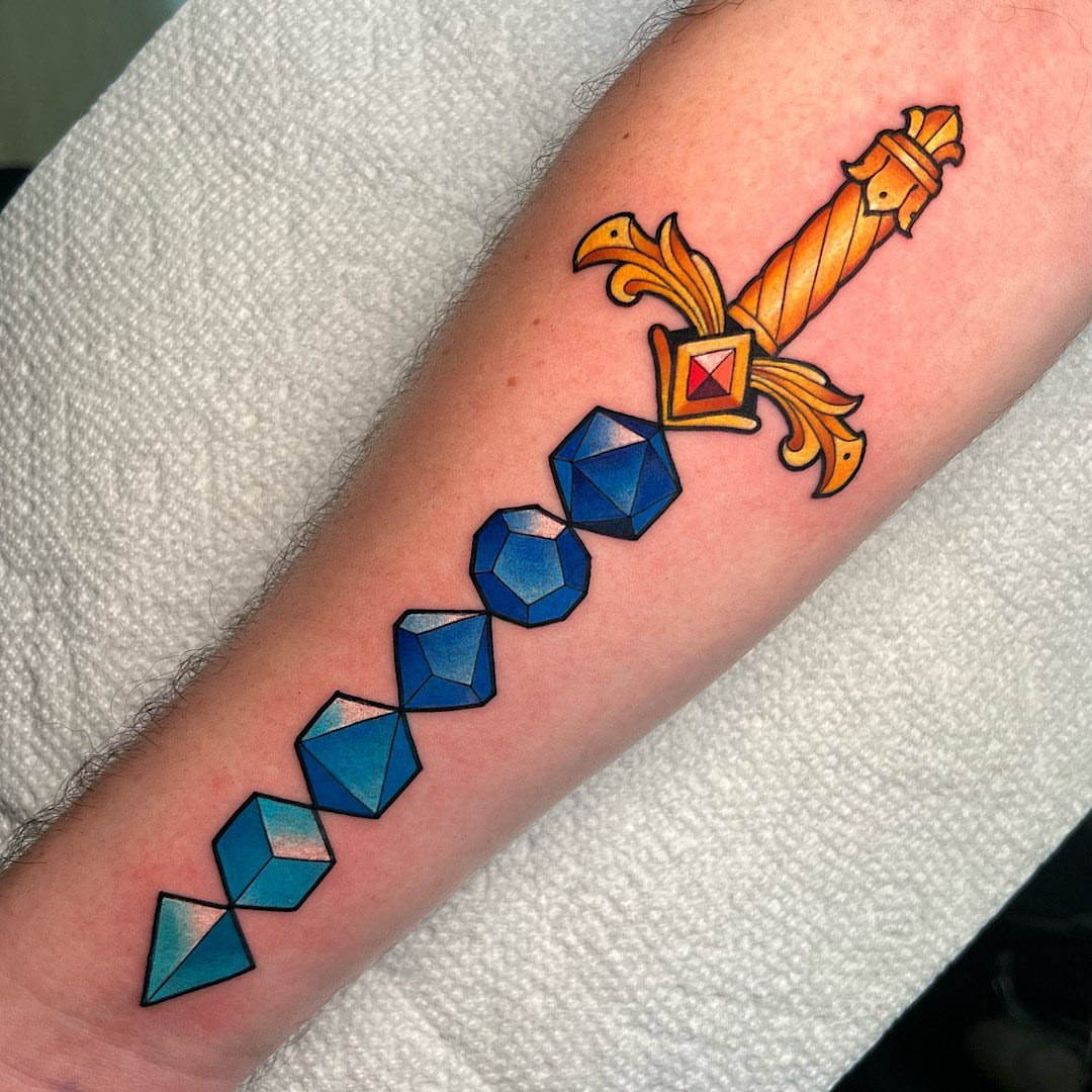 Sword with gemstones geometric tattoo on the forearm by Shelby Ouellette