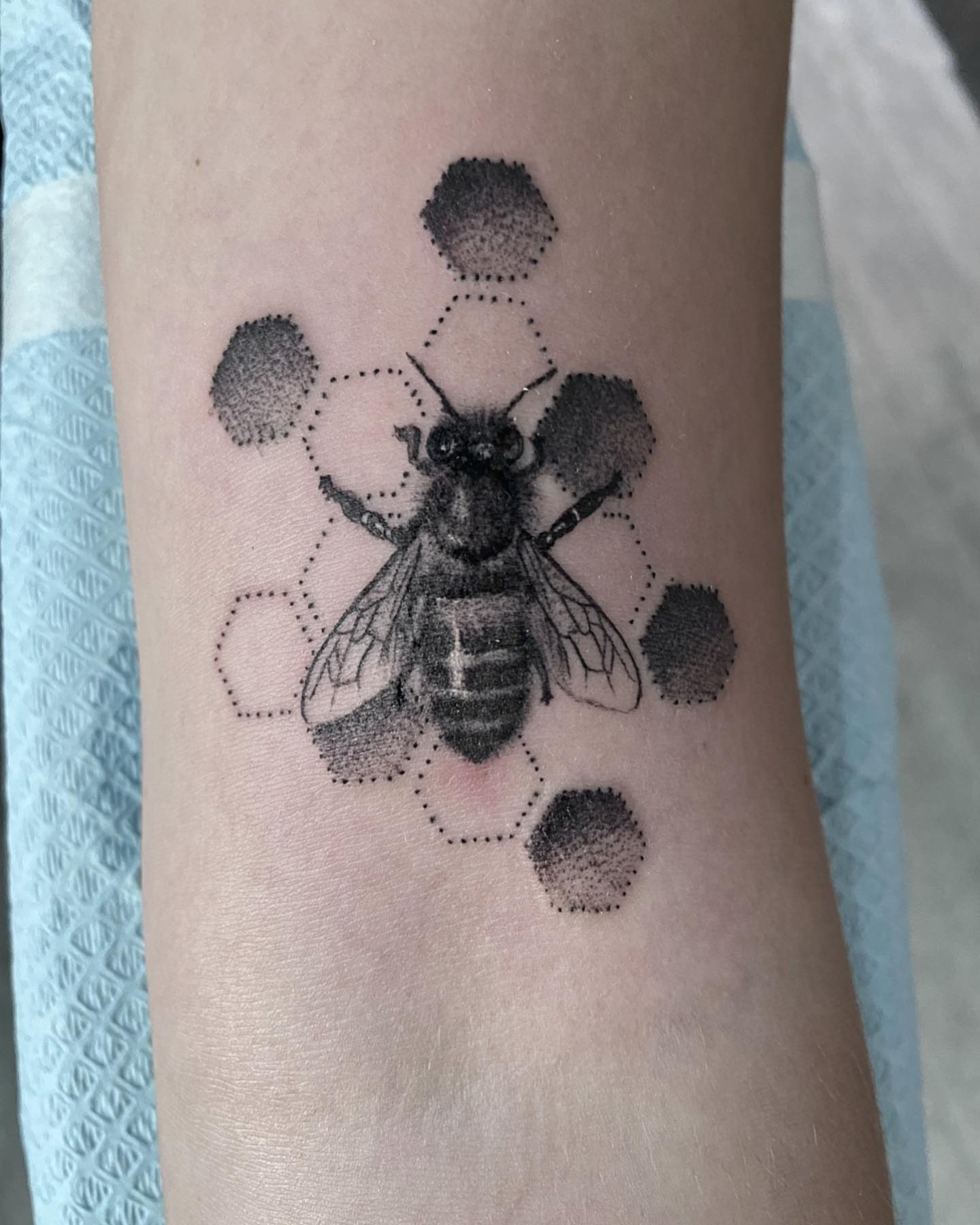Bee dotwork tattoo on the forearm by Douglas