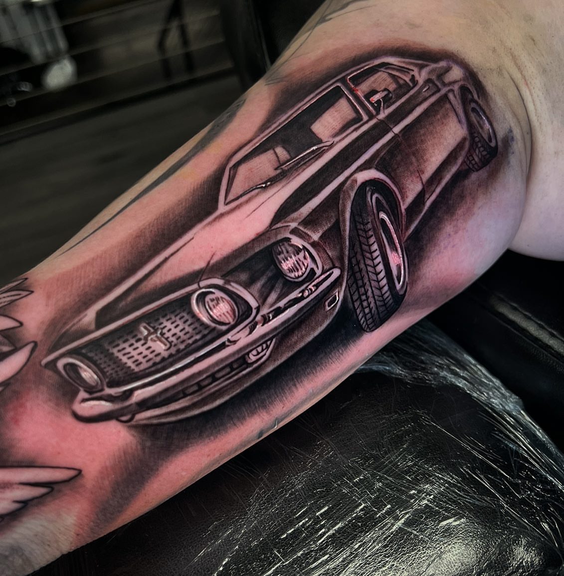 Muscle car realism tattoo on the forearm by Angel Lizarraga