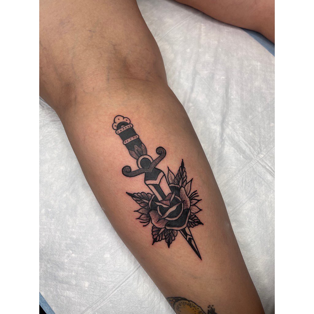 Sword and rose black and grey tattoo on the forearm by Jelly