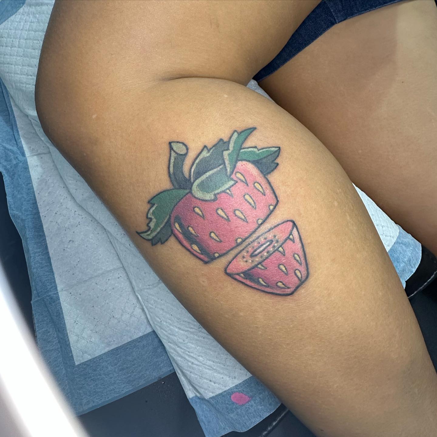 Strawberry American traditional tattoo on the thigh by Sarah Bobby, Houston, Texas