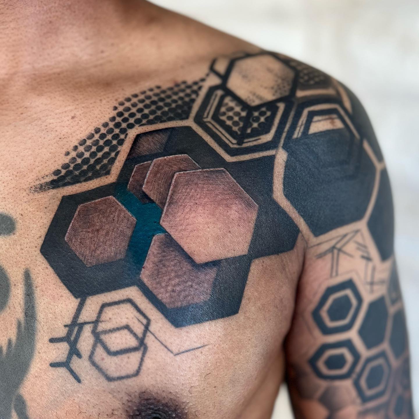 Hexagons geometric tattoo on the shoulder by Emily Jestine Francis