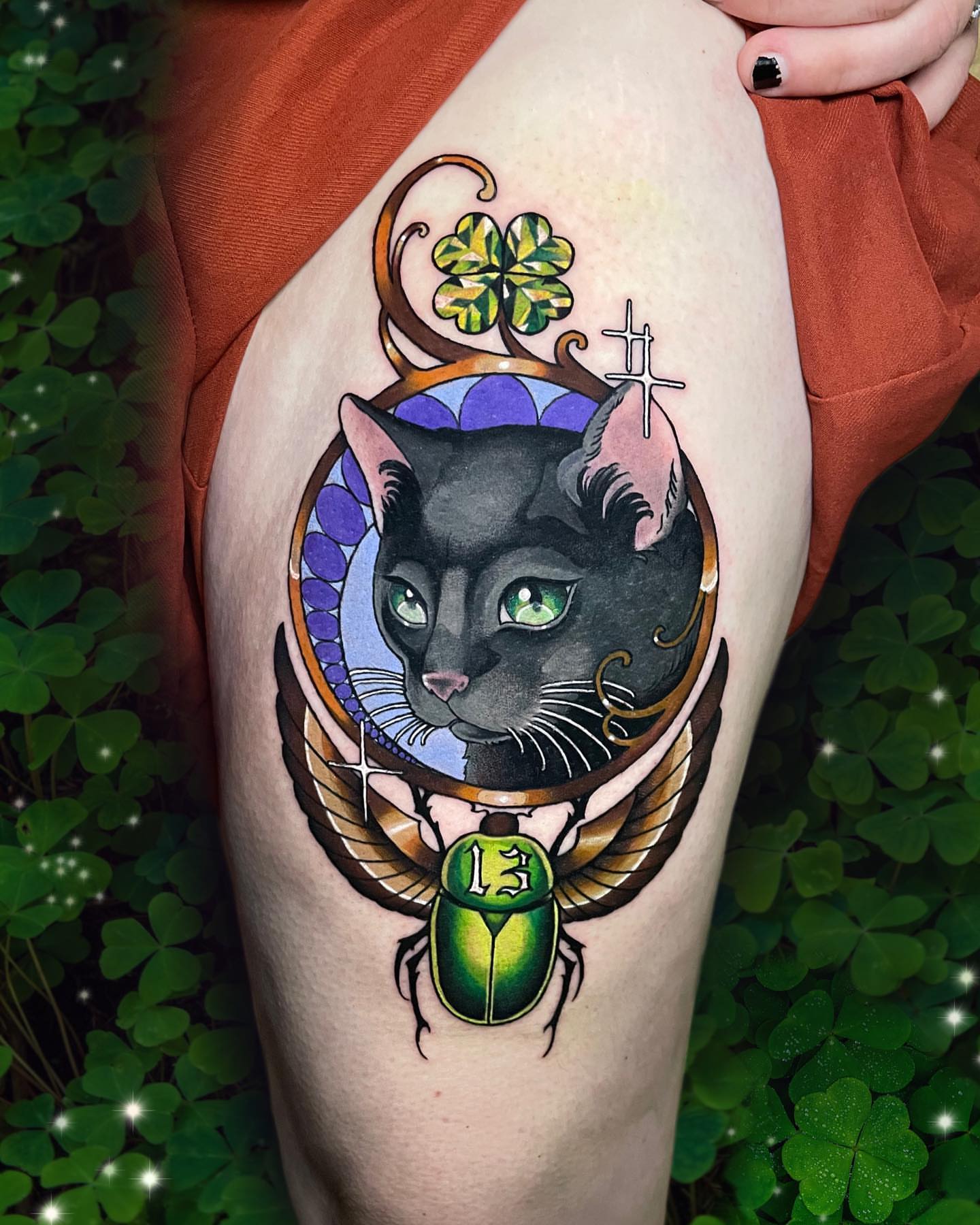 Black cat with scarab beetle American traditional tattoo on the thigh by Wendy Ruiz
