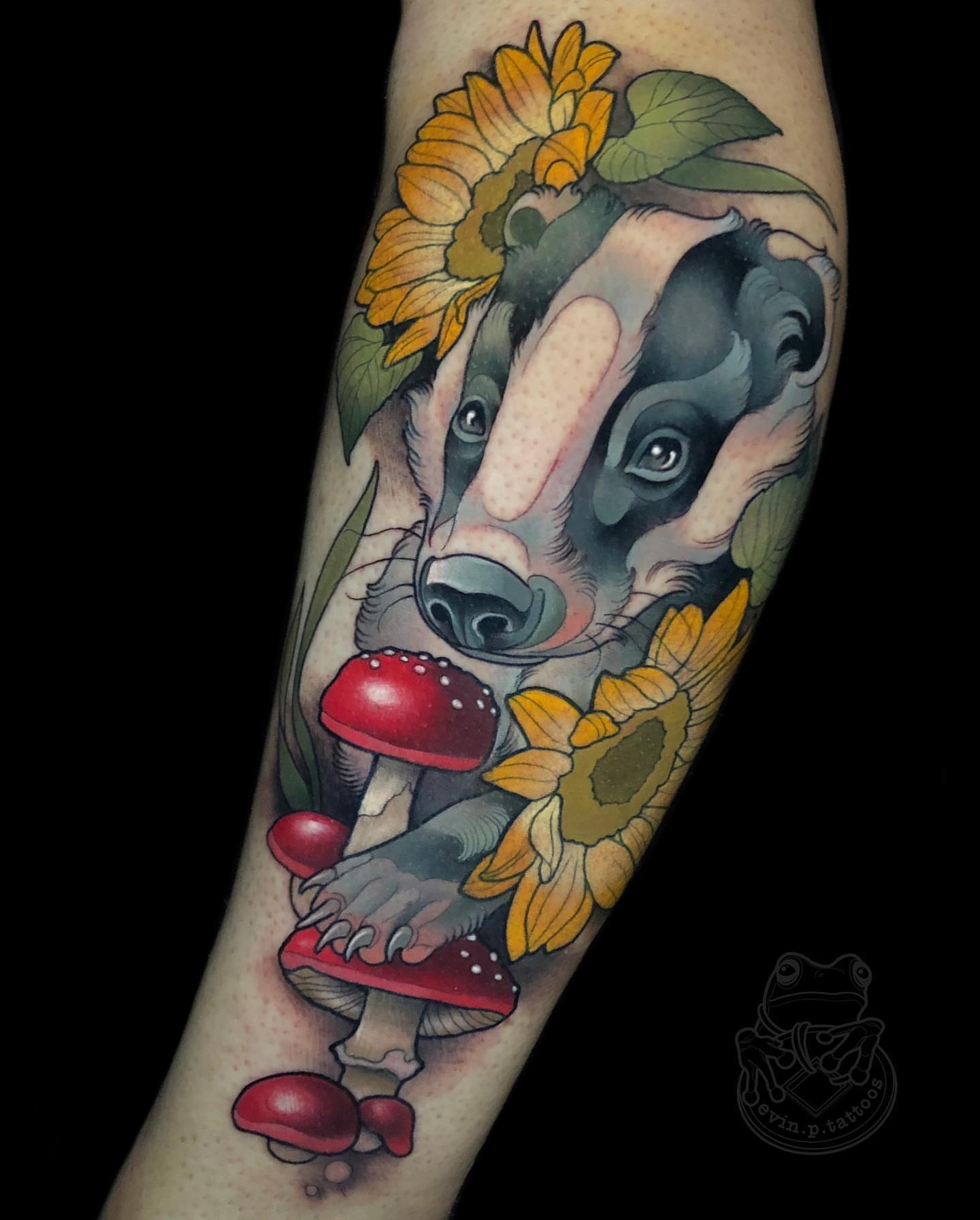 Badger with mushrooms and sunflowers realism tattoo on the forearm by Evin Pfaff, Bedford, Pennsylvania