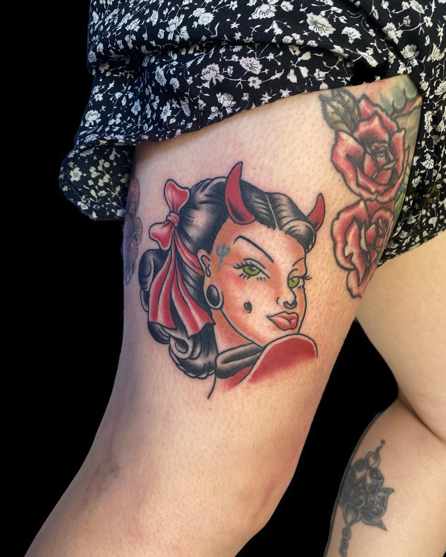 Pin-up girl American traditional tattoo on the thigh by Shelby Warren