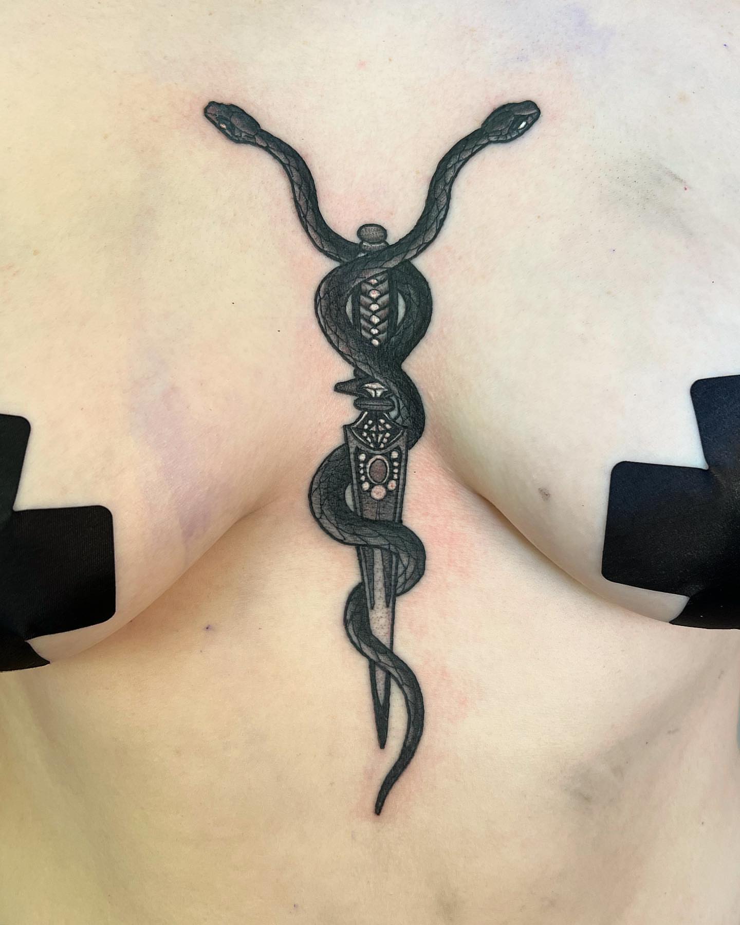 Snake and dagger black and grey tattoo on the back by Daniel Patrick