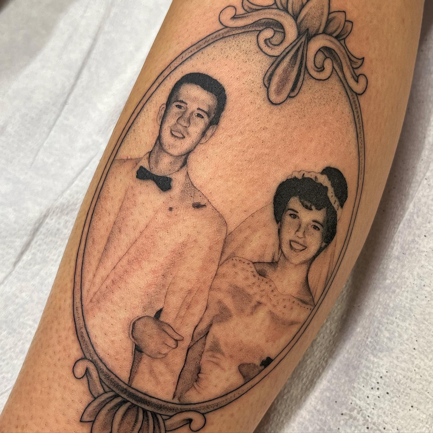 Couple portrait black and grey tattoo on the forearm by liliana lopez