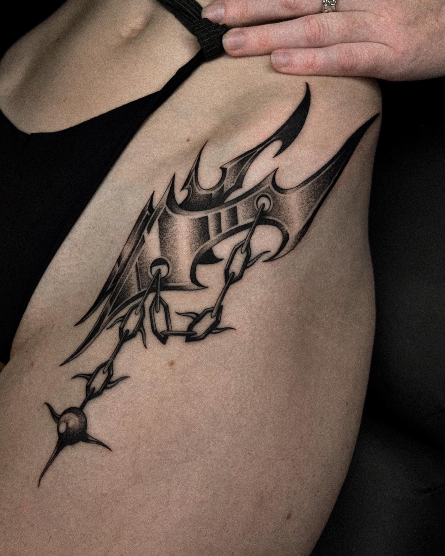 Thorned wings tribal tattoo on the thigh by David Ha