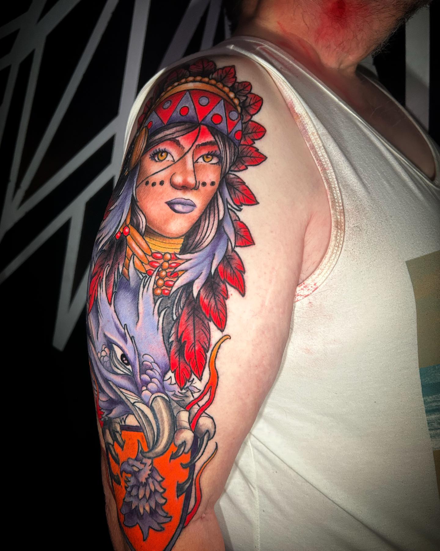 Indian woman with dragon American traditional tattoo on the upper arm by Sean Cavanaugh