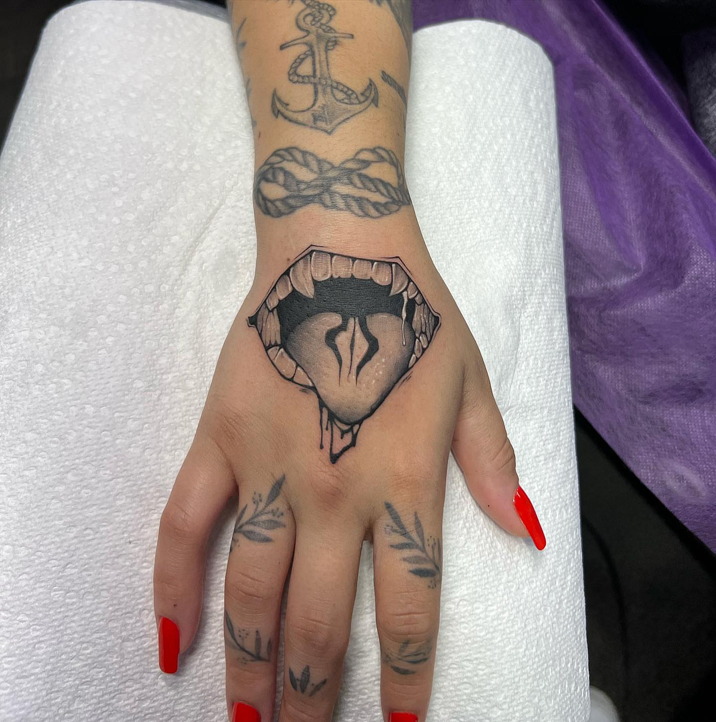 Mouth with teeth black and grey tattoo on the hand by Denis Morello de Castro, South River, New Jersey