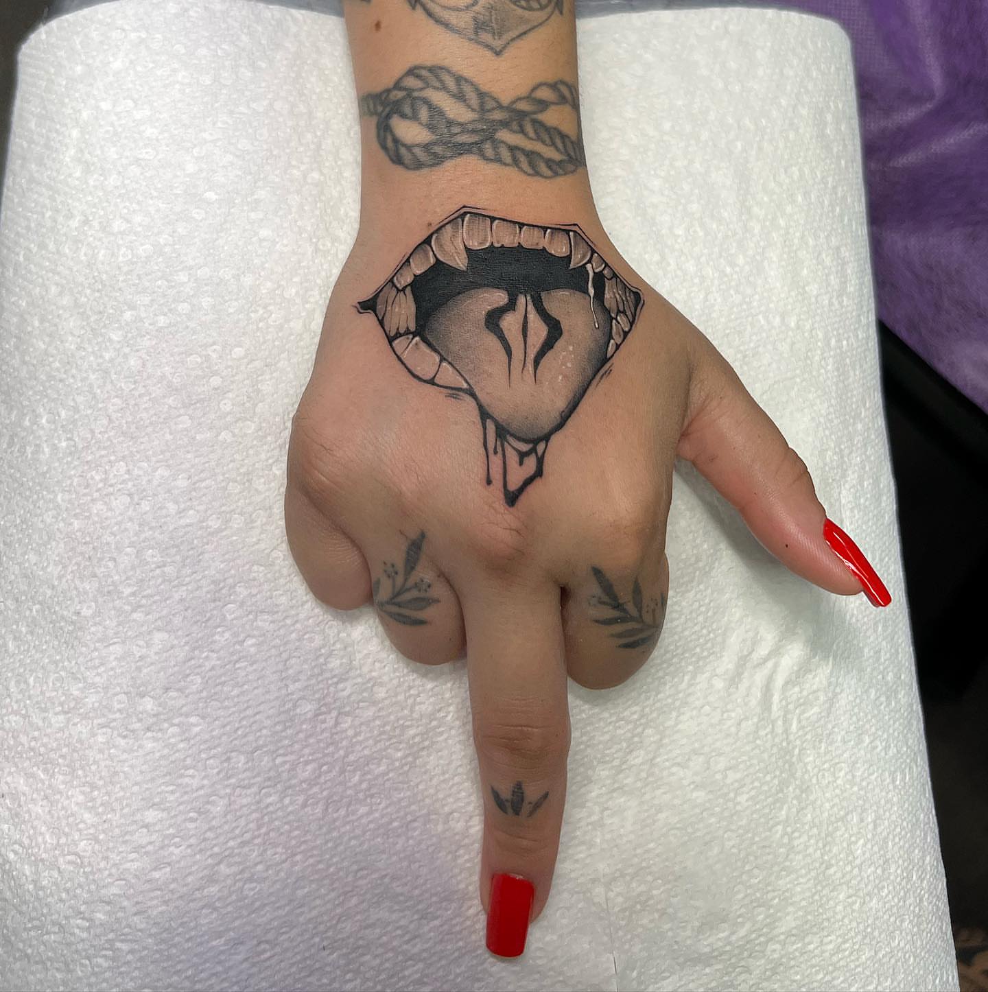 Mouth black and grey tattoo on the hand by Denis Morello de Castro, South River, New Jersey