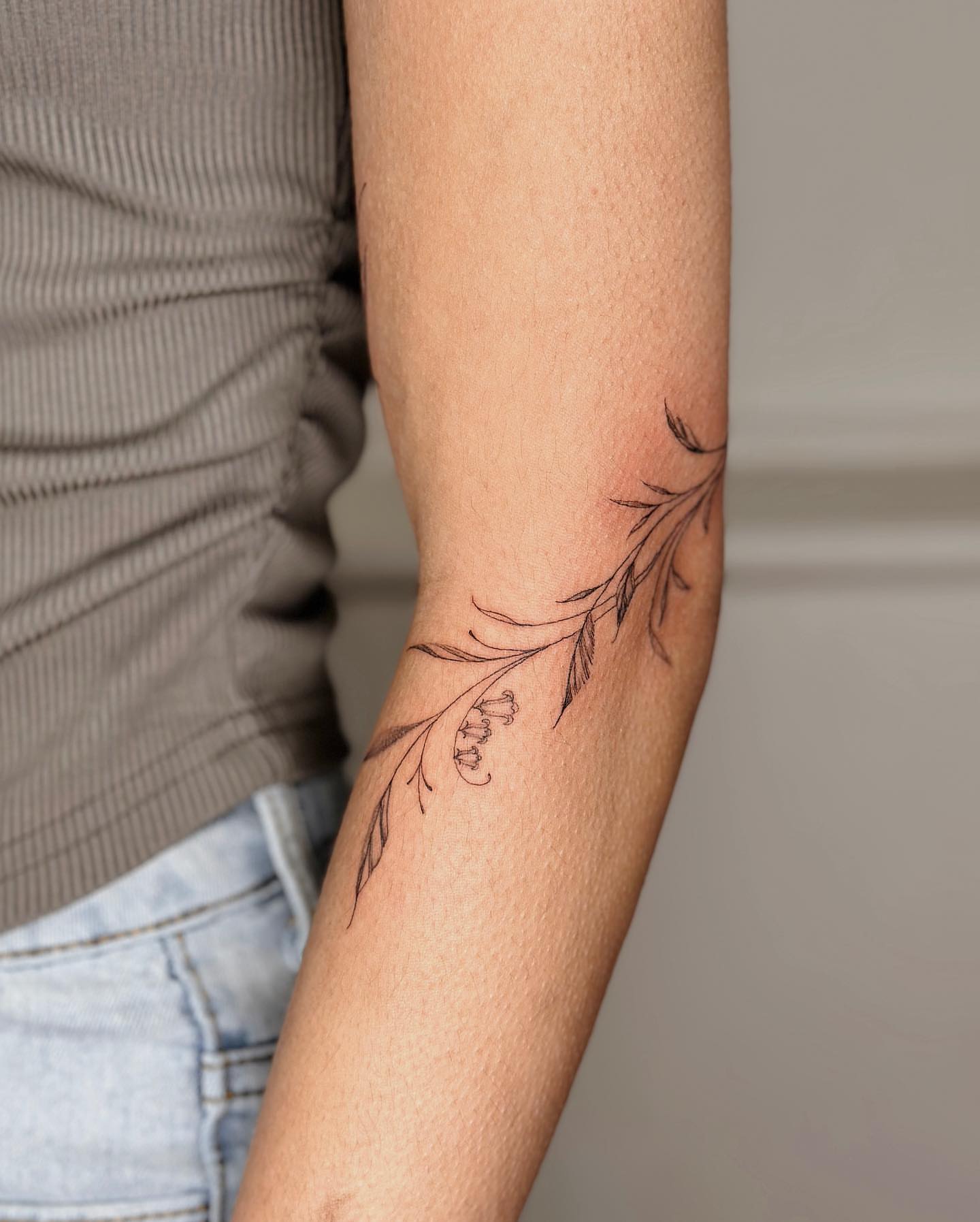 Branch with leaves fine line tattoo on the forearm by ๐๐๐๐๐๐๐