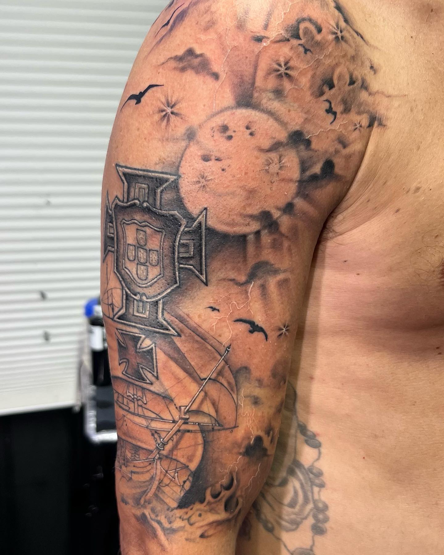 Space-themed celestial body realism tattoo on the upper arm by Denis Morello de Castro, South River, New Jersey