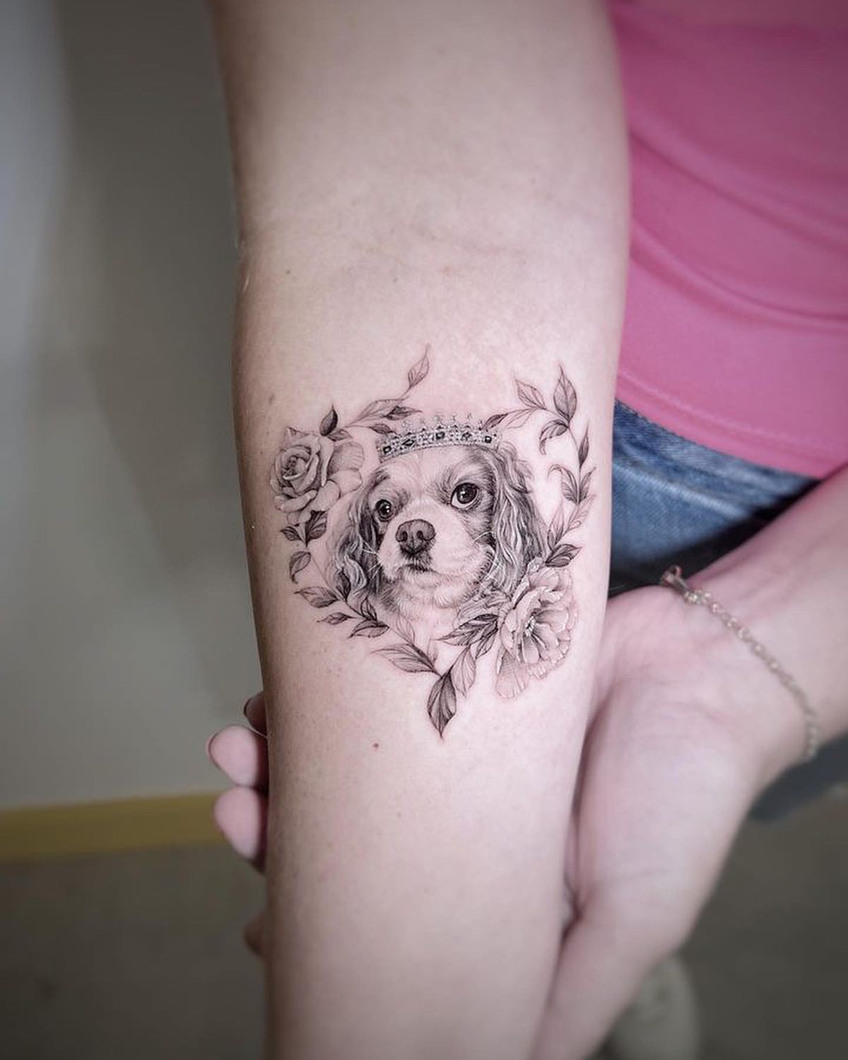 Dog with crown realism tattoo on the forearm by Nana