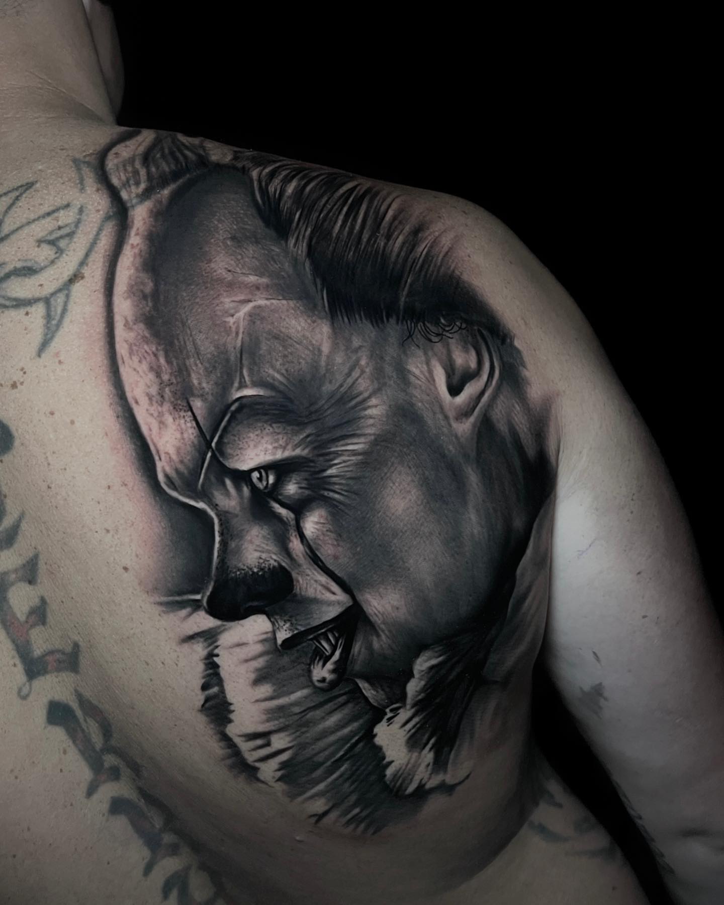 Clown realism tattoo on the shoulder by Matt Misiak