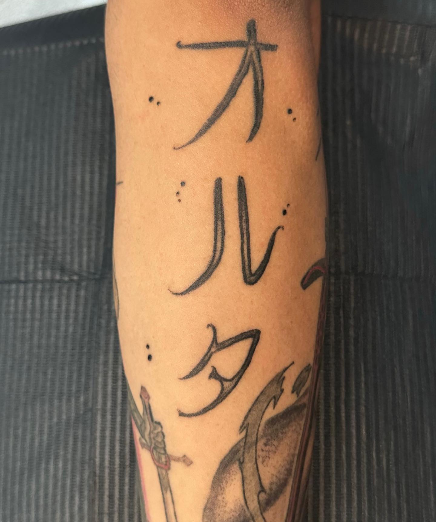 Kanji characters dotwork tattoo on the forearm by Mika