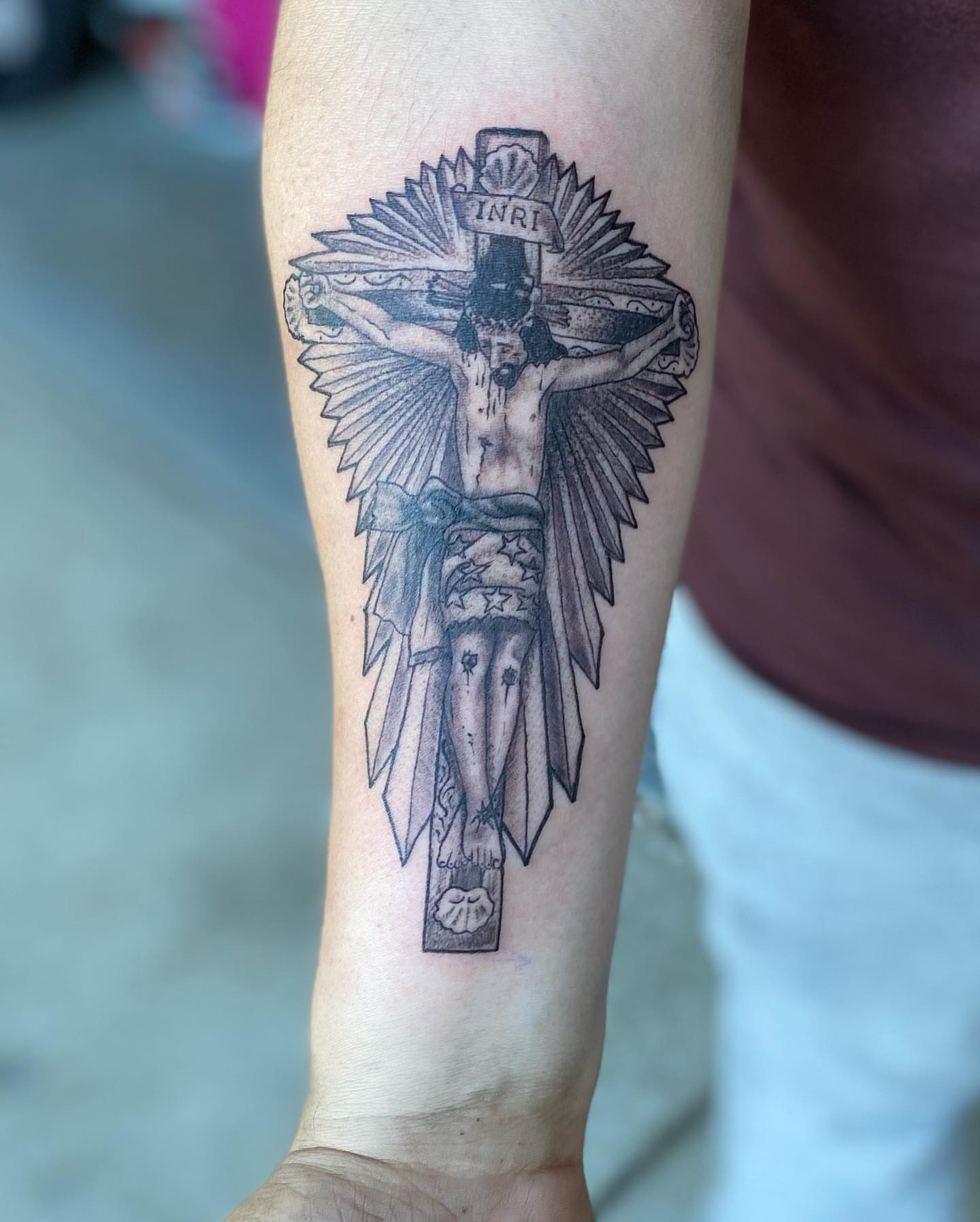 Crucifixion scene black and grey tattoo on the forearm by Chino's Tattoos