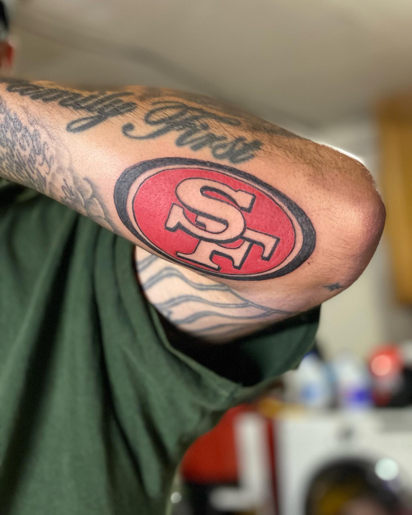 49ers logo American traditional tattoo on the forearm by Chino's Tattoos