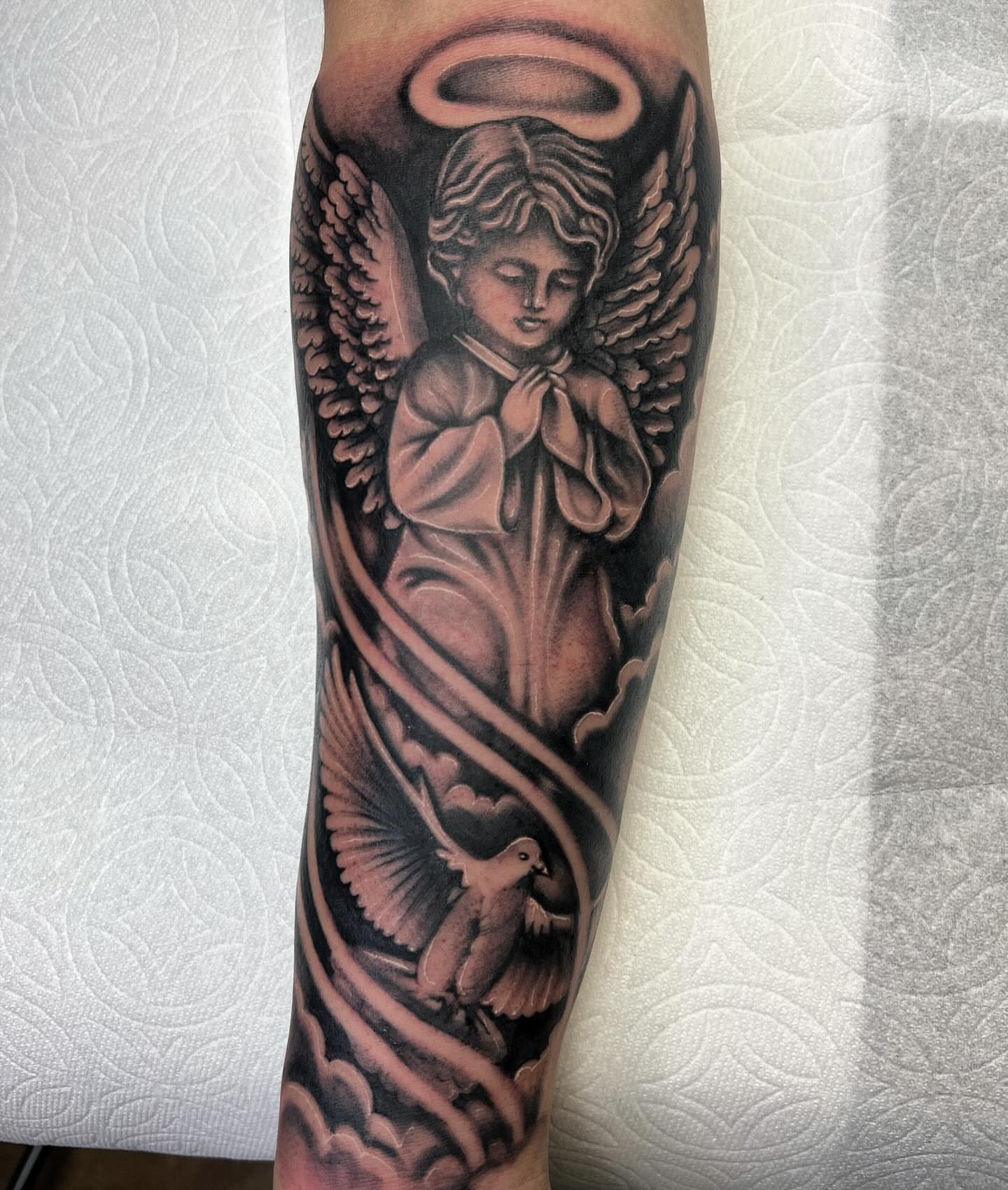 Angel with dove black and grey tattoo on the forearm by Summer Rain