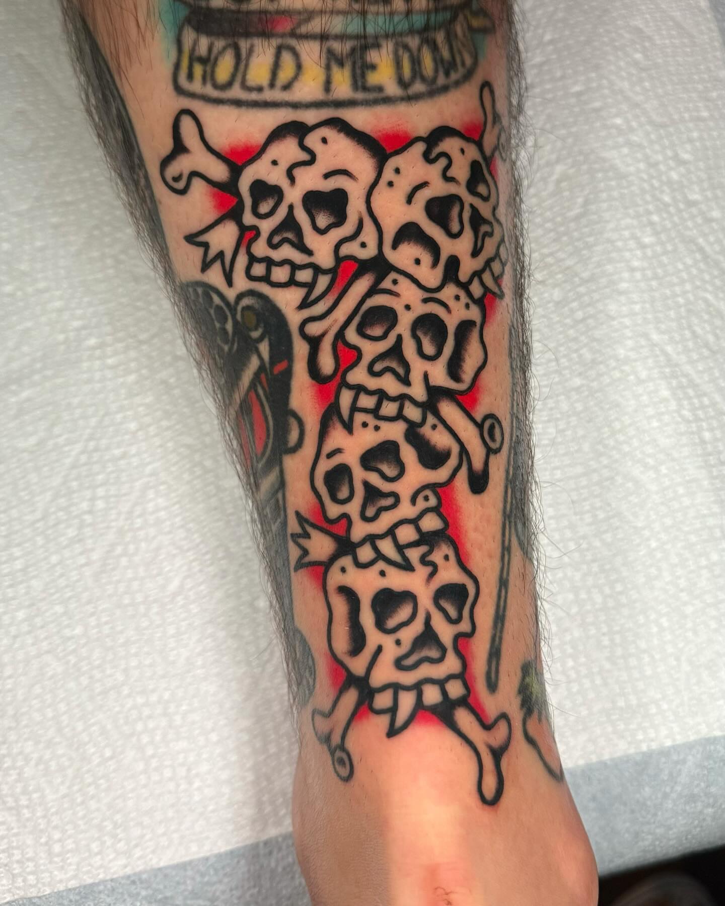 Skulls American traditional tattoo on the forearm by James Shepherd, Austin, Texas