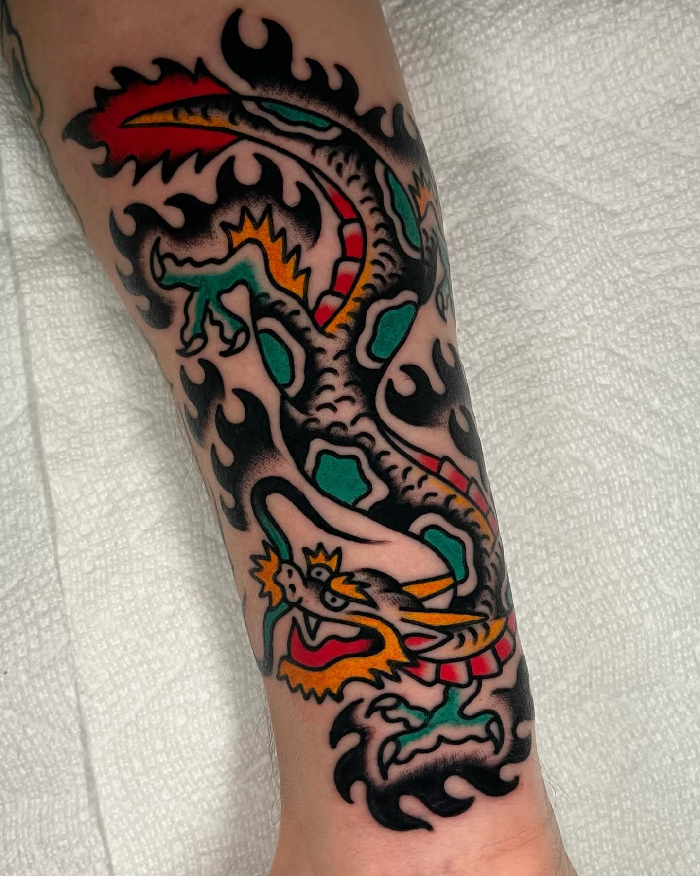 Dragon American traditional tattoo on the forearm by James Shepherd, Austin, Texas