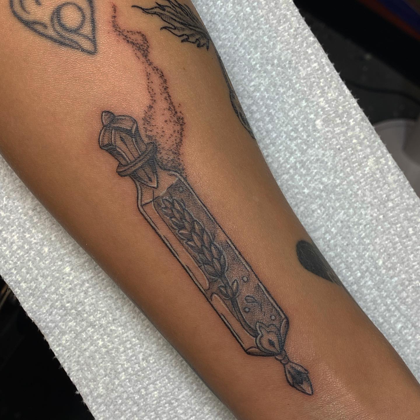 Sword black and grey tattoo on the forearm by Maddie Neibert