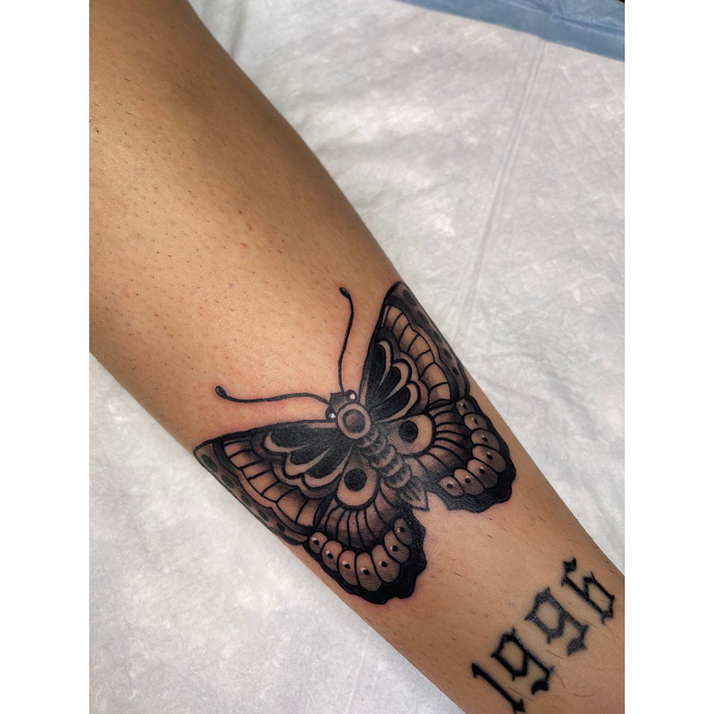 Butterfly black and grey tattoo on the forearm by Jelly