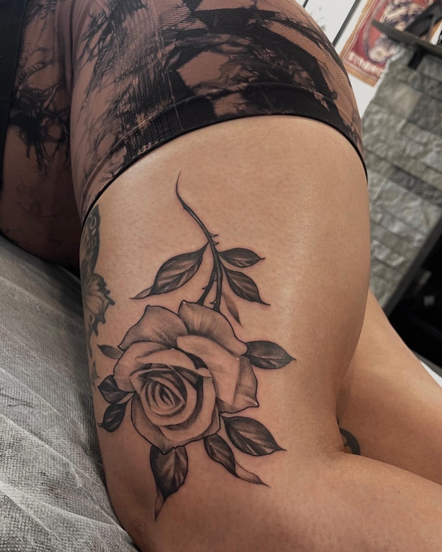 Rose black and grey tattoo on the thigh by Morrison Vo