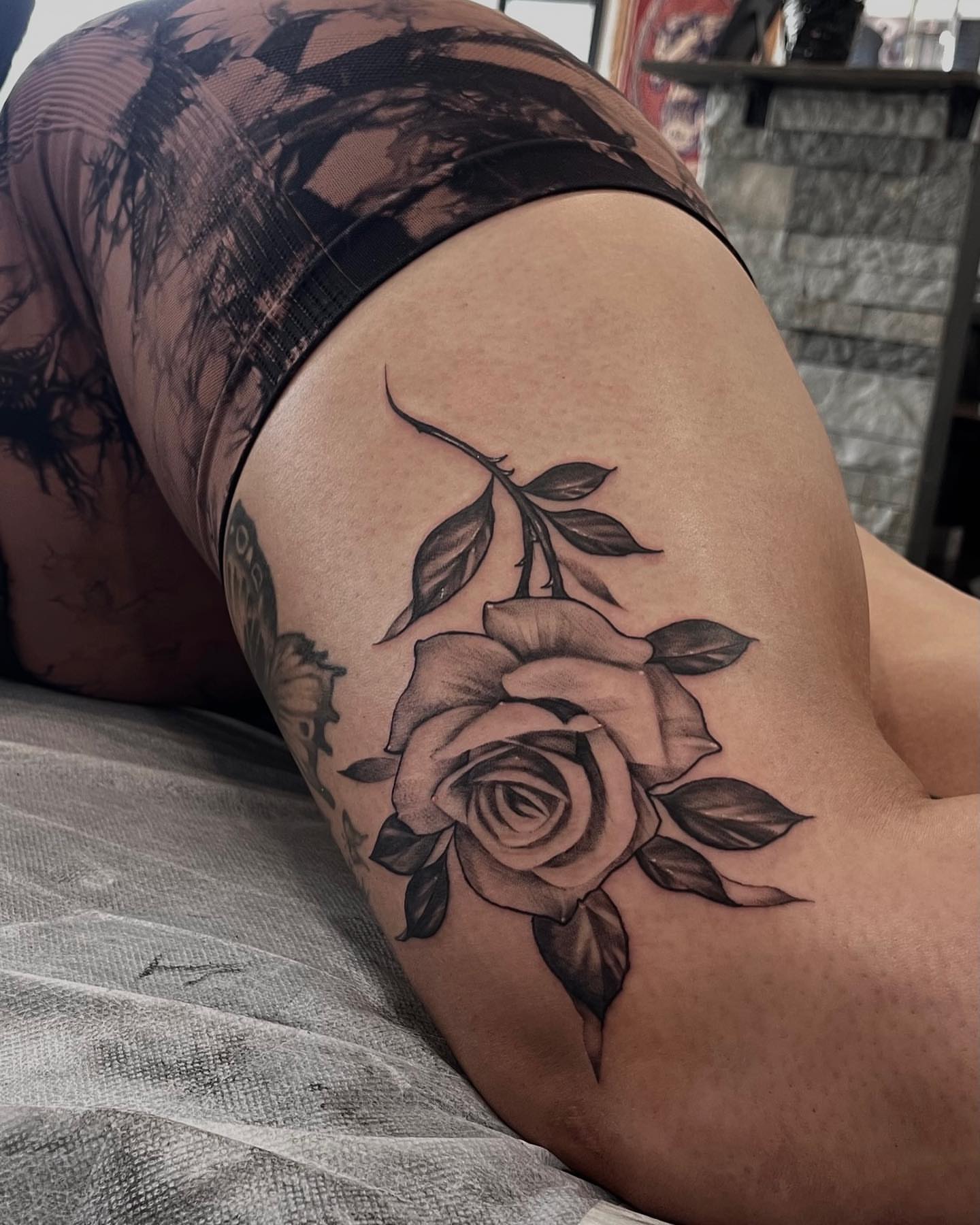 Rose black and grey tattoo on the thigh by Morrison Vo