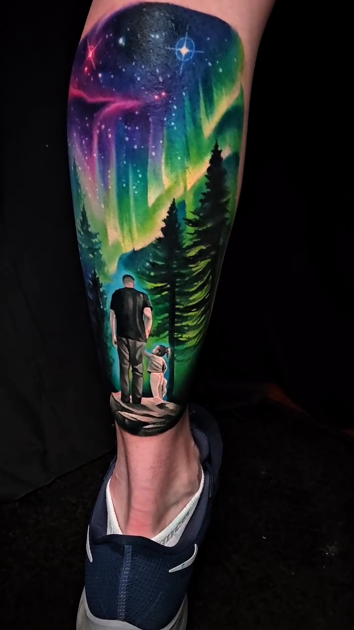 Aurora borealis and forest realism tattoo by Tyler Malek