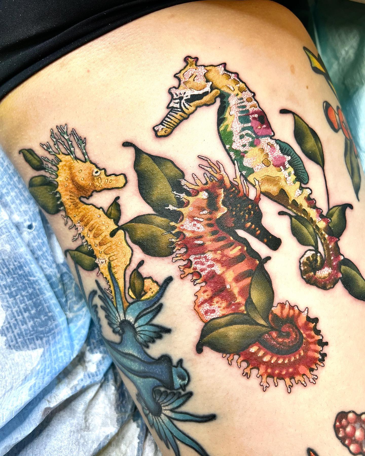 Seahorses and sea creatures American traditional tattoo on the thigh by Pam Sanders