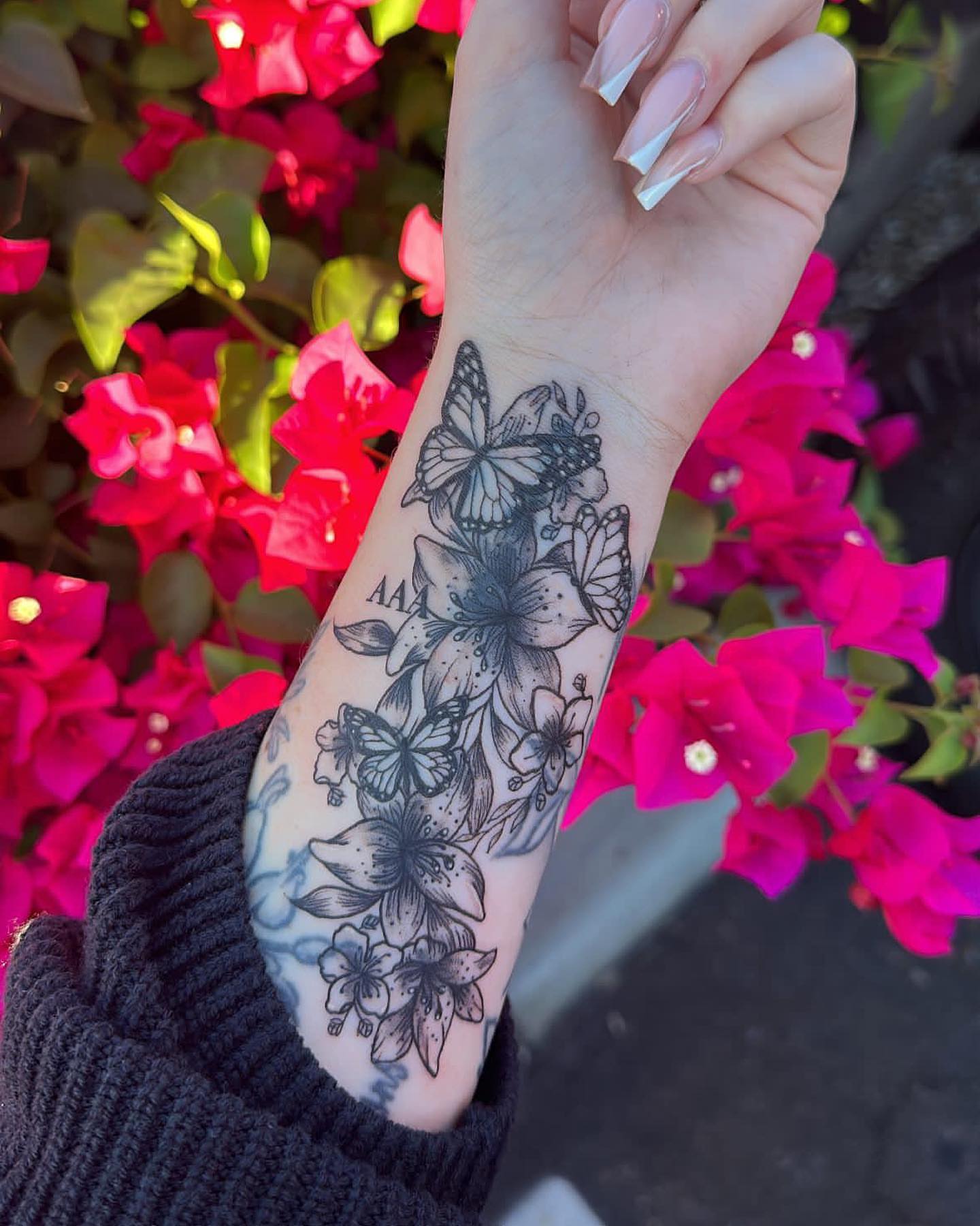 Flowers and butterflies black and grey tattoo on the forearm by josselyn ☪︎