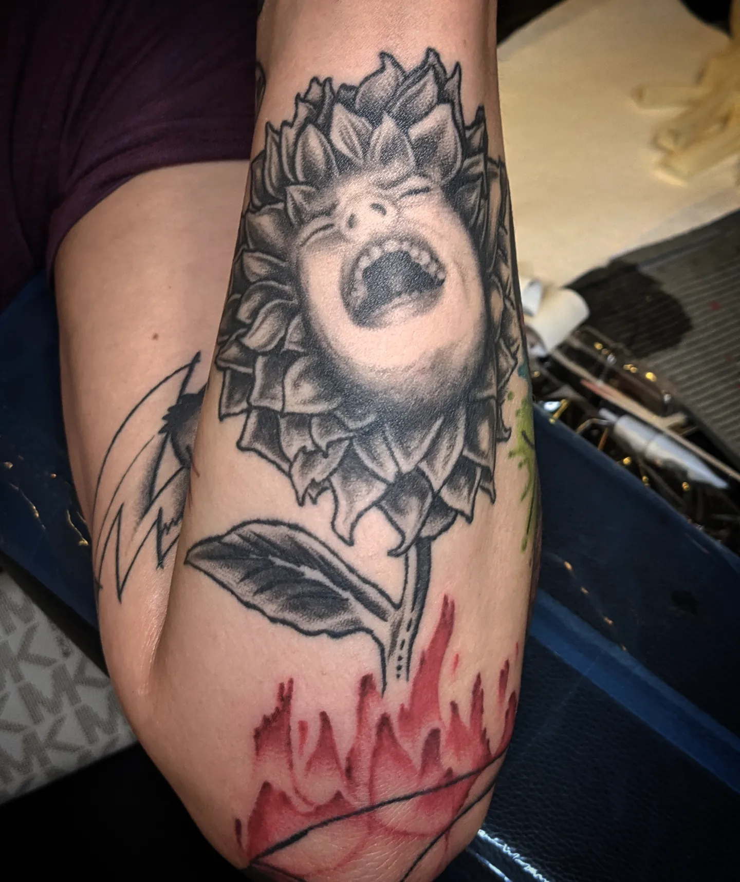 Sunflower with screaming face realism tattoo on the forearm by Krista Mc