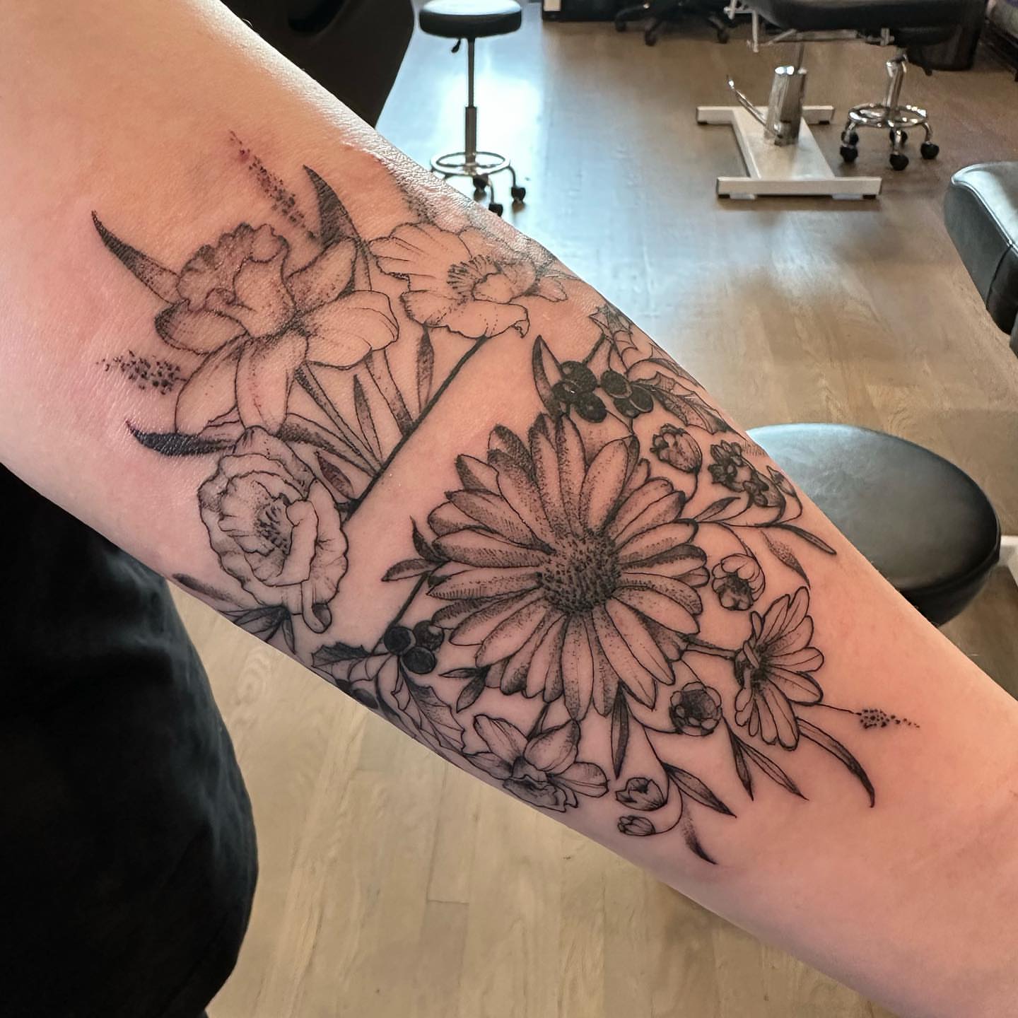 Floral arrangement dotwork tattoo on the forearm by Matthew Clanin