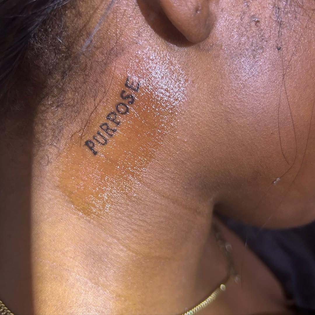 Word 'Purpose' lettering tattoo on the neck by ๐ฆ